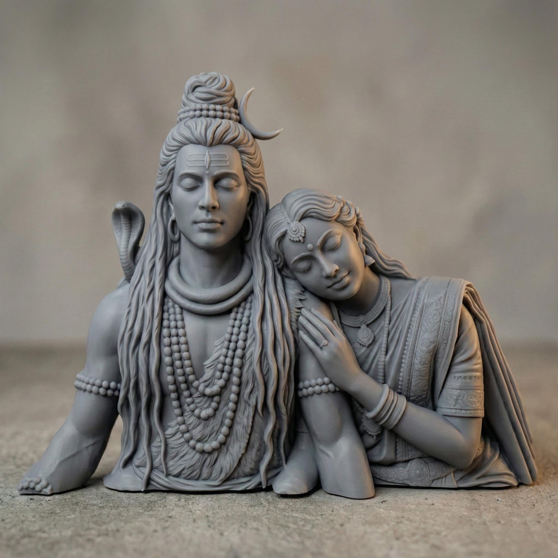 Detailed 3D STL model of Lord Shiva and Goddess Parvati depicted as a serene divine couple, sculpted in a realistic wooden carving style. Parvati rests gently on Shiva’s shoulder, symbolizing love, balance, and devotion. The model features intricate hair, jewelry, facial expressions, and traditional Indian ornaments, designed for CNC wood carving, 3D printing, and religious wall or tabletop decor. Digital STL download for personal or commercial fabrication.