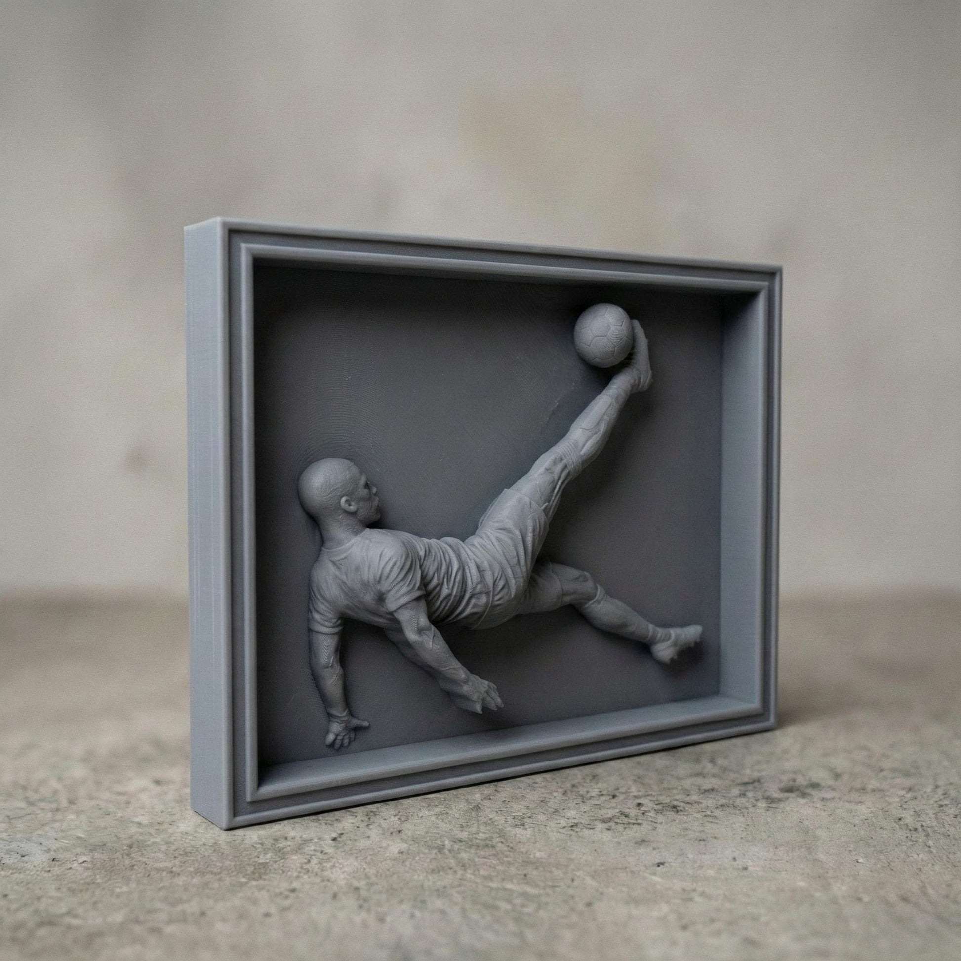 Highly detailed 3D bas-relief of a soccer player performing an overhead bicycle kick, carved in a realistic wood style. The athletic figure is captured mid-air with extended leg striking a football, showcasing dynamic motion, muscle definition, and flowing sportswear. Ideal for CNC carving, 3D printing, and wall-mounted sports decor, symbolizing passion, strength, and competitive spirit in football-inspired art.