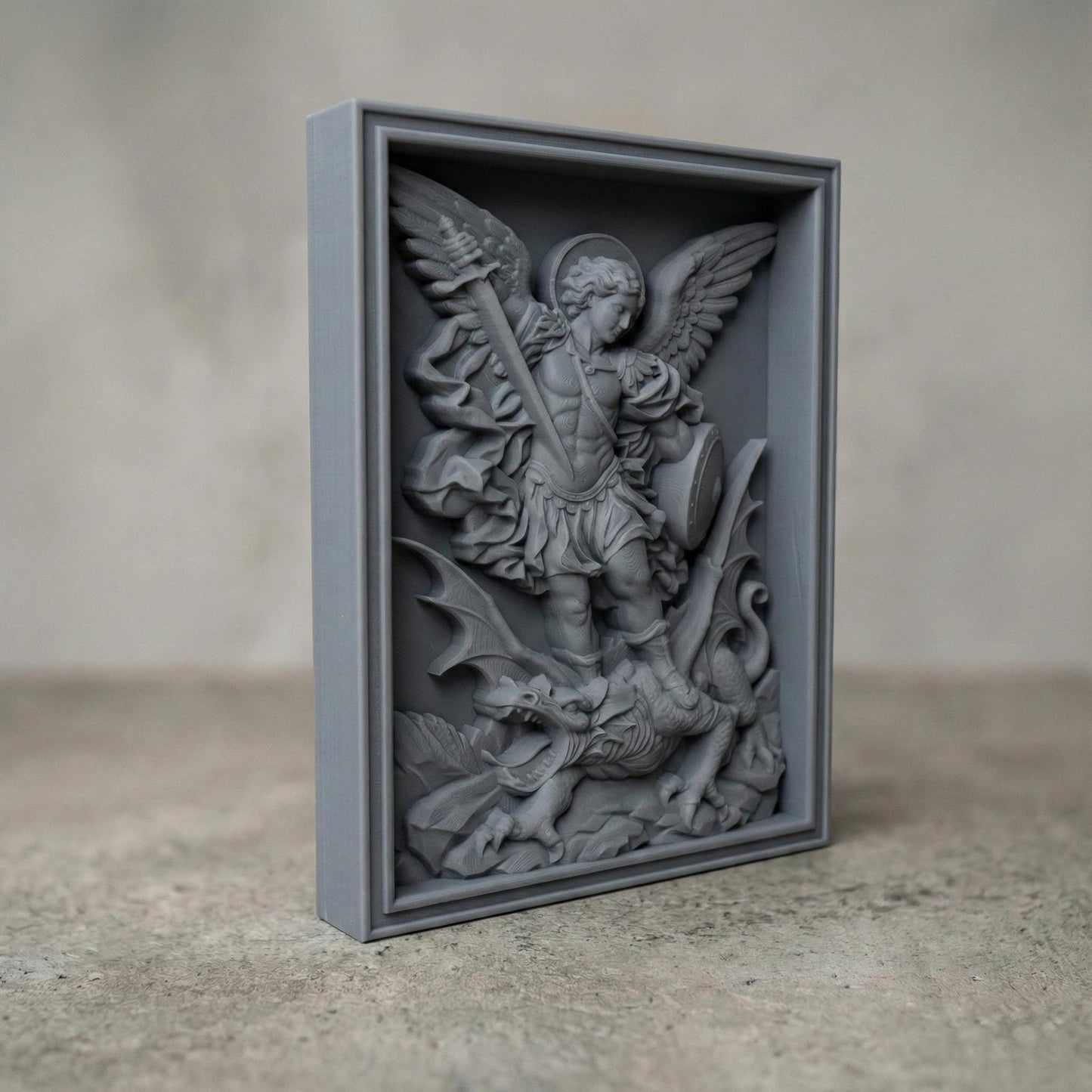 Wooden bas-relief wall art depicting Archangel Michael in dynamic motion, carved in deep relief. The winged angel holds a raised sword and shield while standing triumphantly over a defeated dragon beneath his feet. Flowing robes, detailed feathers, and dramatic cloud forms surround the figure. Rendered in rich carved wood texture with smooth depth transitions, suitable for CNC carving, wood engraving, and religious Christian wall décor.