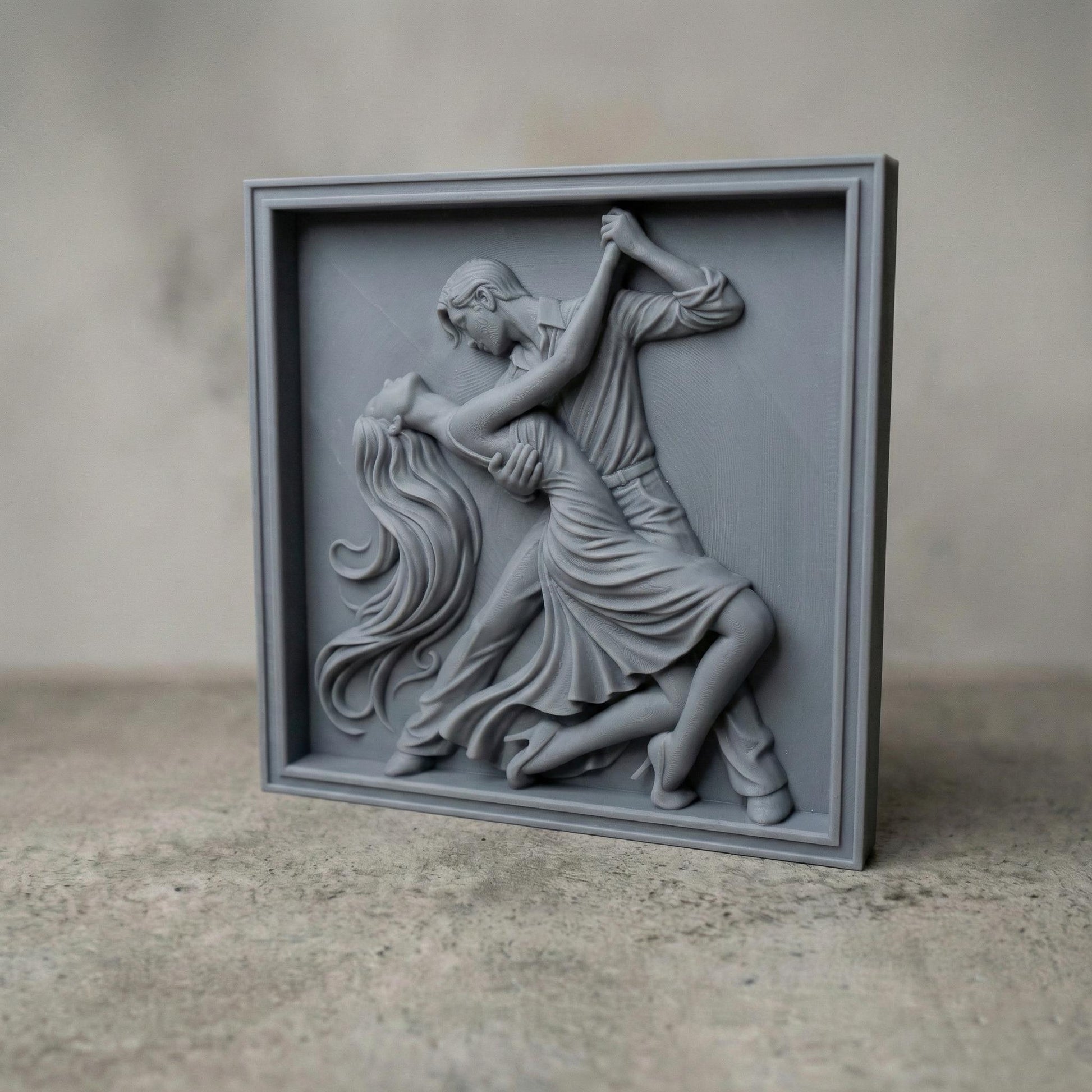 Elegant tango dance couple bas-relief depicting a passionate ballroom pose with flowing dress, intertwined movement, and expressive body language. Detailed sculpted relief designed for CNC carving, 3D printing, or wood engraving, featuring deep contours, smooth curves, and dramatic motion ideal for decorative wall art and artistic relief projects.