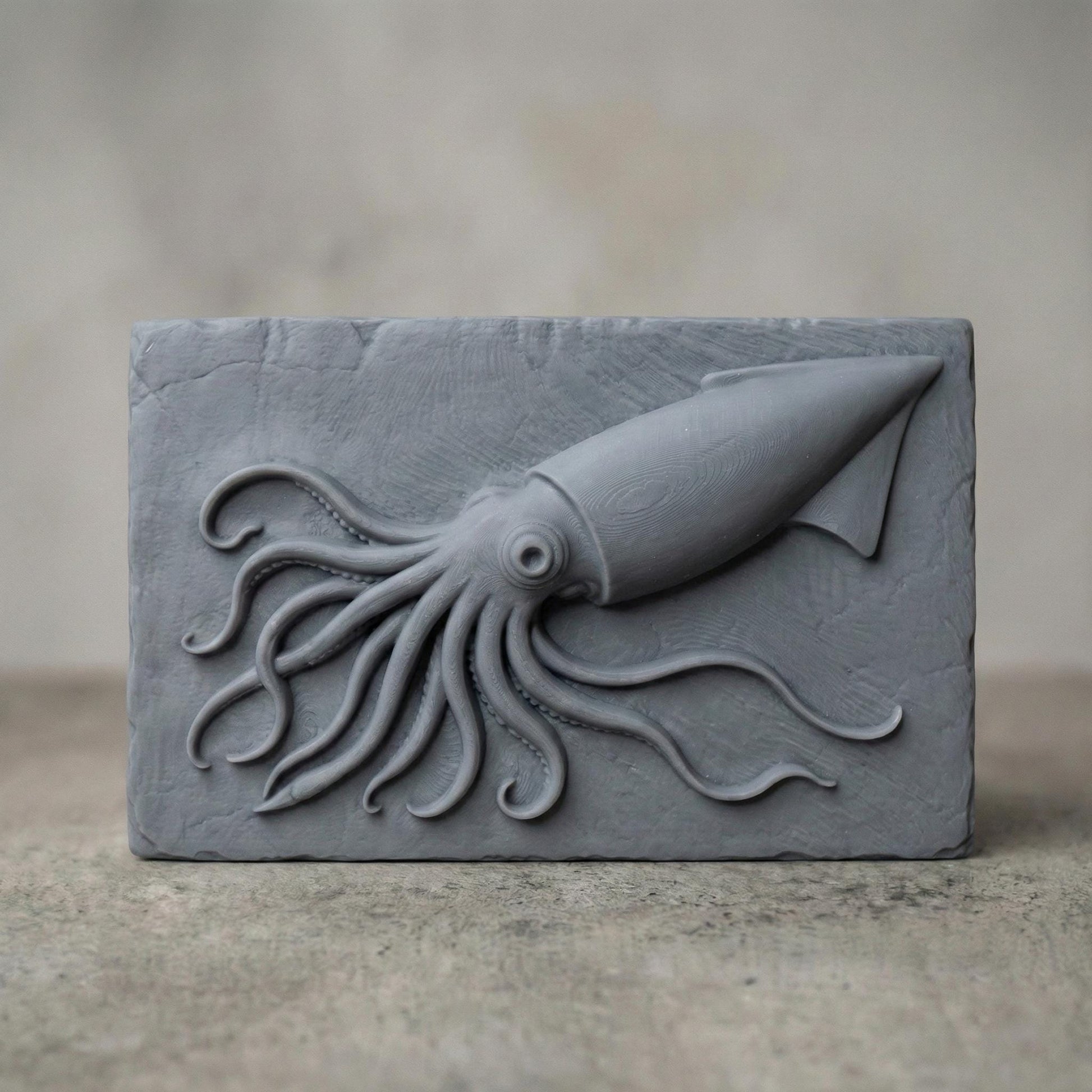 A highly detailed 3D bas relief carving of a squid crafted in a rich reddish-brown wood tone. The squid is positioned diagonally on a rectangular slab with its long tentacles dynamically flowing in various directions, creating a sense of motion. Each tentacle is intricately rendered with natural curvature and suction cups, while the squid’s large eye and streamlined body give it a lifelike presence. The background slab has chipped, rough edges and a vertical wood grain texture.
