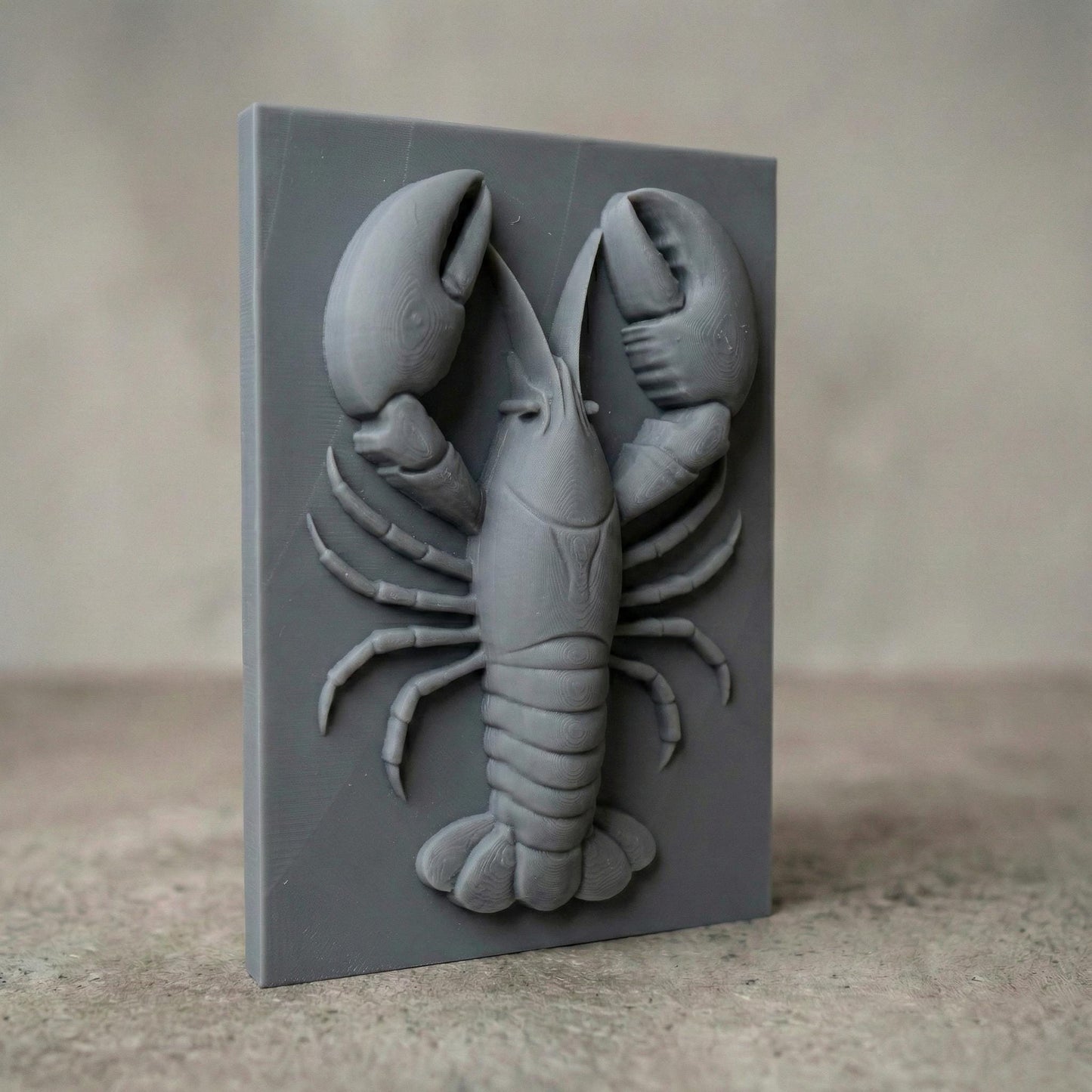 Bring the charm of the sea to your space with this stunning 3D Lobster Bas Relief Wood Art. This digital design captures the intricate form of a lobster in high detail, from its segmented claws to delicate legs, perfect for marine and coastal-themed interiors. Ideal for CNC carving or laser engraving, the panel includes subtle wood grain detail and chipped-edge slab aesthetics for a handcrafted, rustic feel. A perfect fit for beach homes, seafood restaurants, or nautical gift lovers.