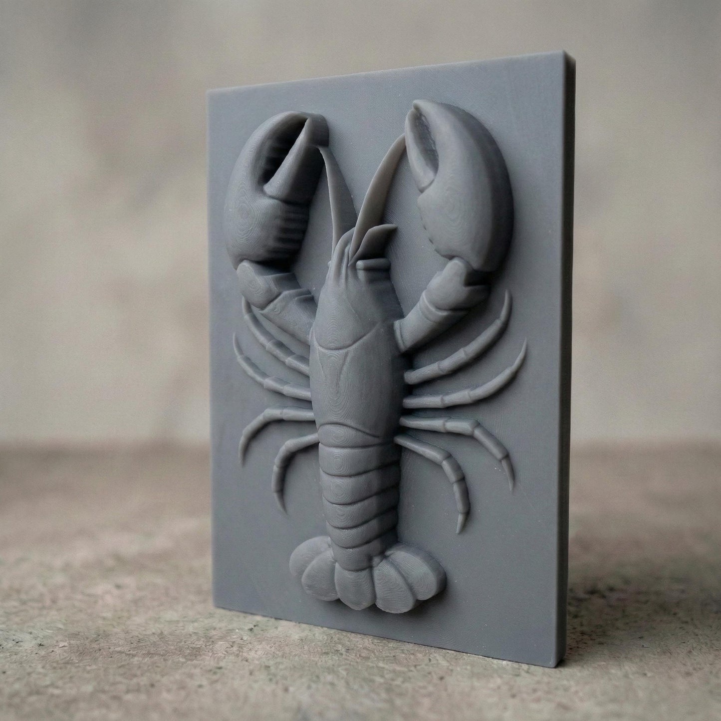 Bring the charm of the sea to your space with this stunning 3D Lobster Bas Relief Wood Art. This digital design captures the intricate form of a lobster in high detail, from its segmented claws to delicate legs, perfect for marine and coastal-themed interiors. Ideal for CNC carving or laser engraving, the panel includes subtle wood grain detail and chipped-edge slab aesthetics for a handcrafted, rustic feel. A perfect fit for beach homes, seafood restaurants, or nautical gift lovers.