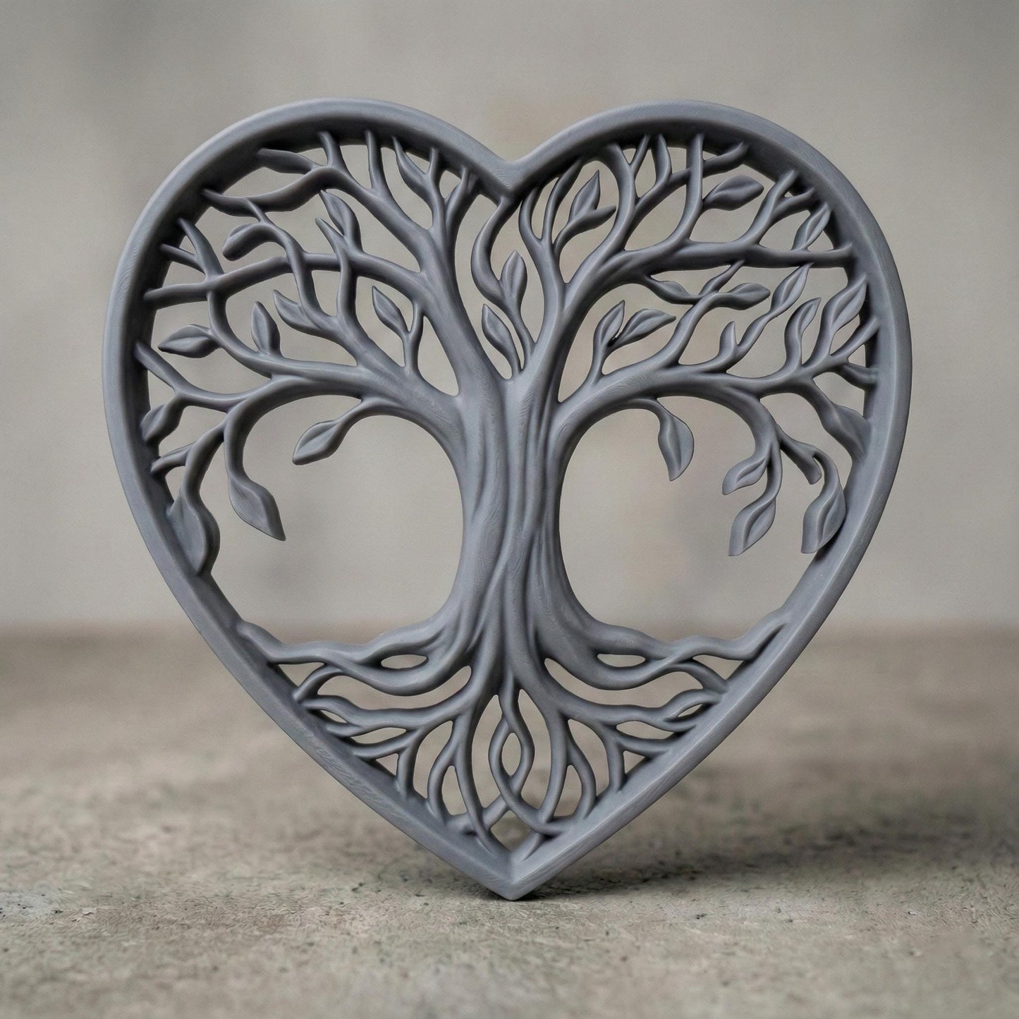 Intricate heart-shaped Tree of Life sculpture featuring flowing branches, detailed leaves, and intertwined roots forming a symmetrical openwork design. The elegant wooden-style relief symbolizes love, growth, family connection, and harmony. Designed as a decorative wall art or tabletop piece, perfect for CNC carving, laser cutting, or 3D printing projects with fine organic details.