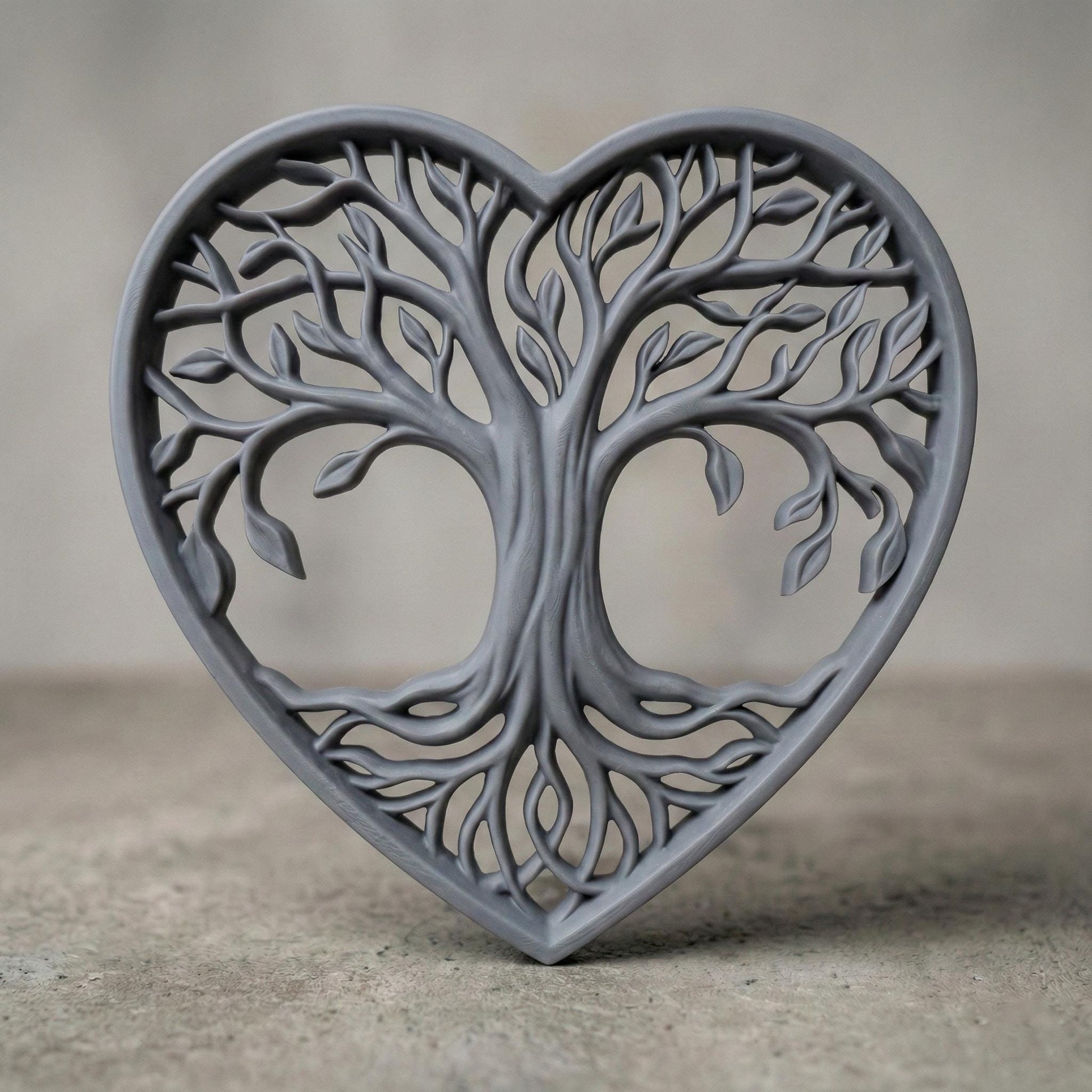 Intricate heart-shaped Tree of Life sculpture featuring flowing branches, detailed leaves, and intertwined roots forming a symmetrical openwork design. The elegant wooden-style relief symbolizes love, growth, family connection, and harmony. Designed as a decorative wall art or tabletop piece, perfect for CNC carving, laser cutting, or 3D printing projects with fine organic details.