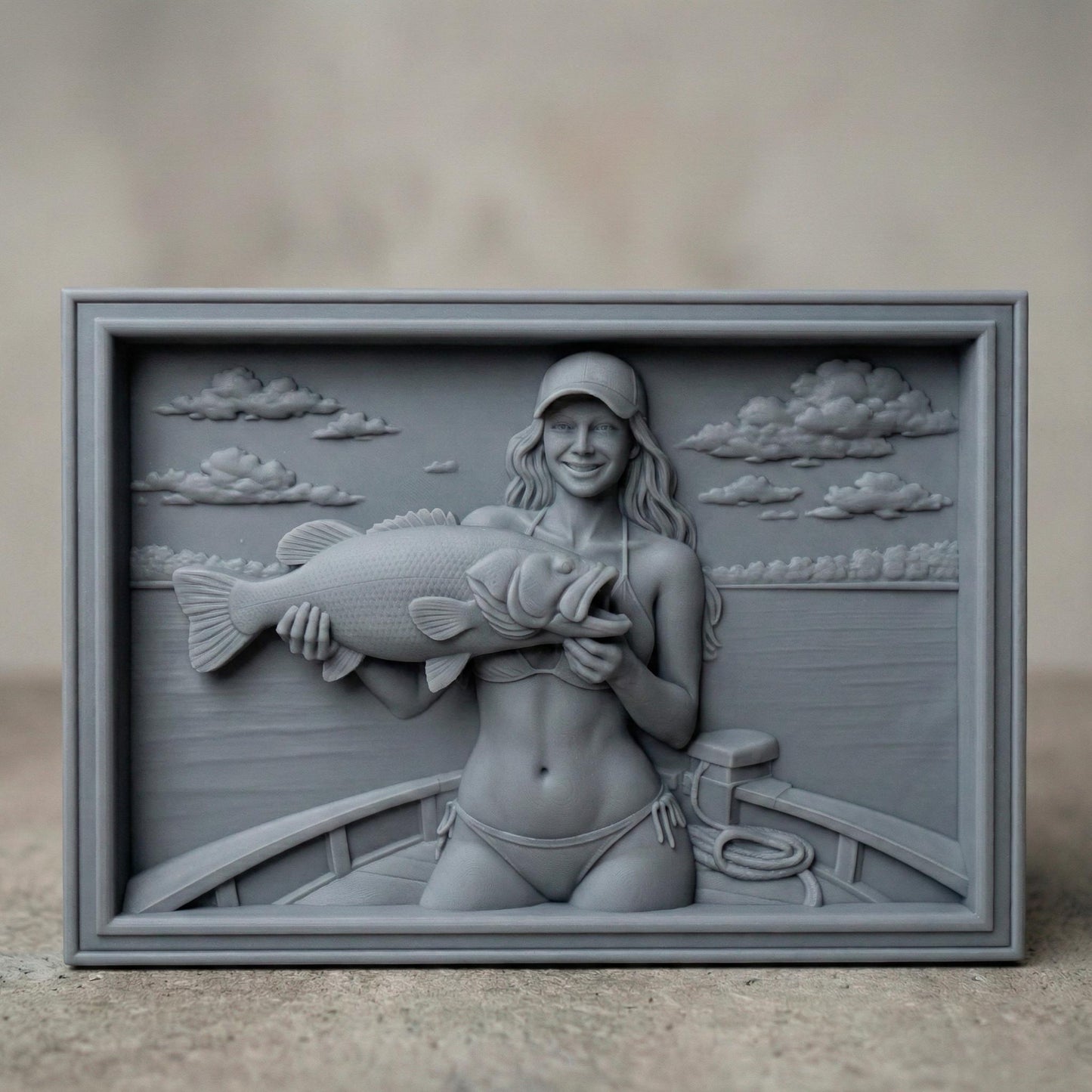 Detailed bas-relief carving of a smiling female angler holding a large bass fish while standing on a boat. The scene features calm lake water, carved clouds in the sky, and realistic wood grain texture. The rectangular framed panel highlights fine details in the fish scales, facial expression, and boat elements, designed for CNC carving or 3D printing as rustic fishing wall decor.