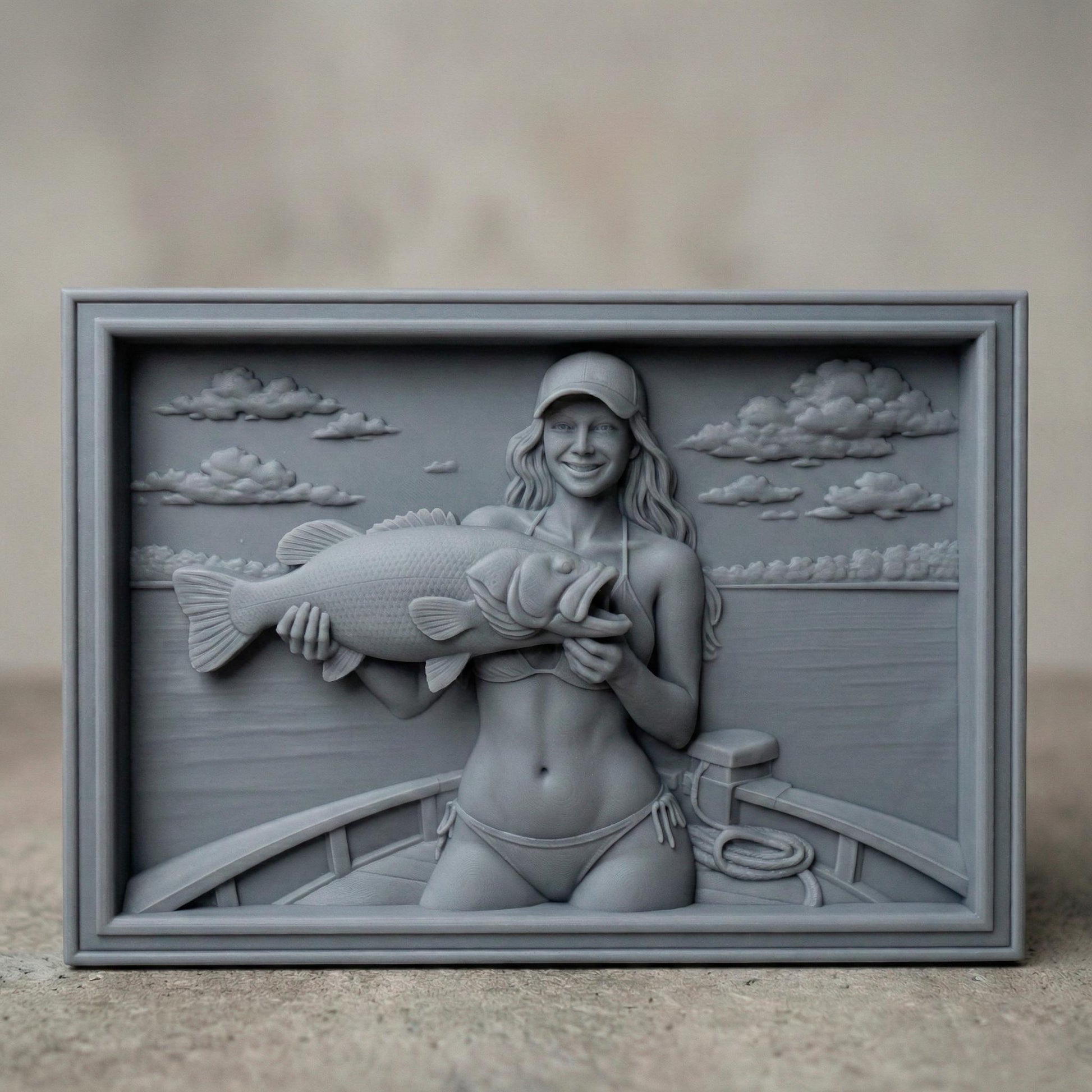 Detailed bas-relief carving of a smiling female angler holding a large bass fish while standing on a boat. The scene features calm lake water, carved clouds in the sky, and realistic wood grain texture. The rectangular framed panel highlights fine details in the fish scales, facial expression, and boat elements, designed for CNC carving or 3D printing as rustic fishing wall decor.