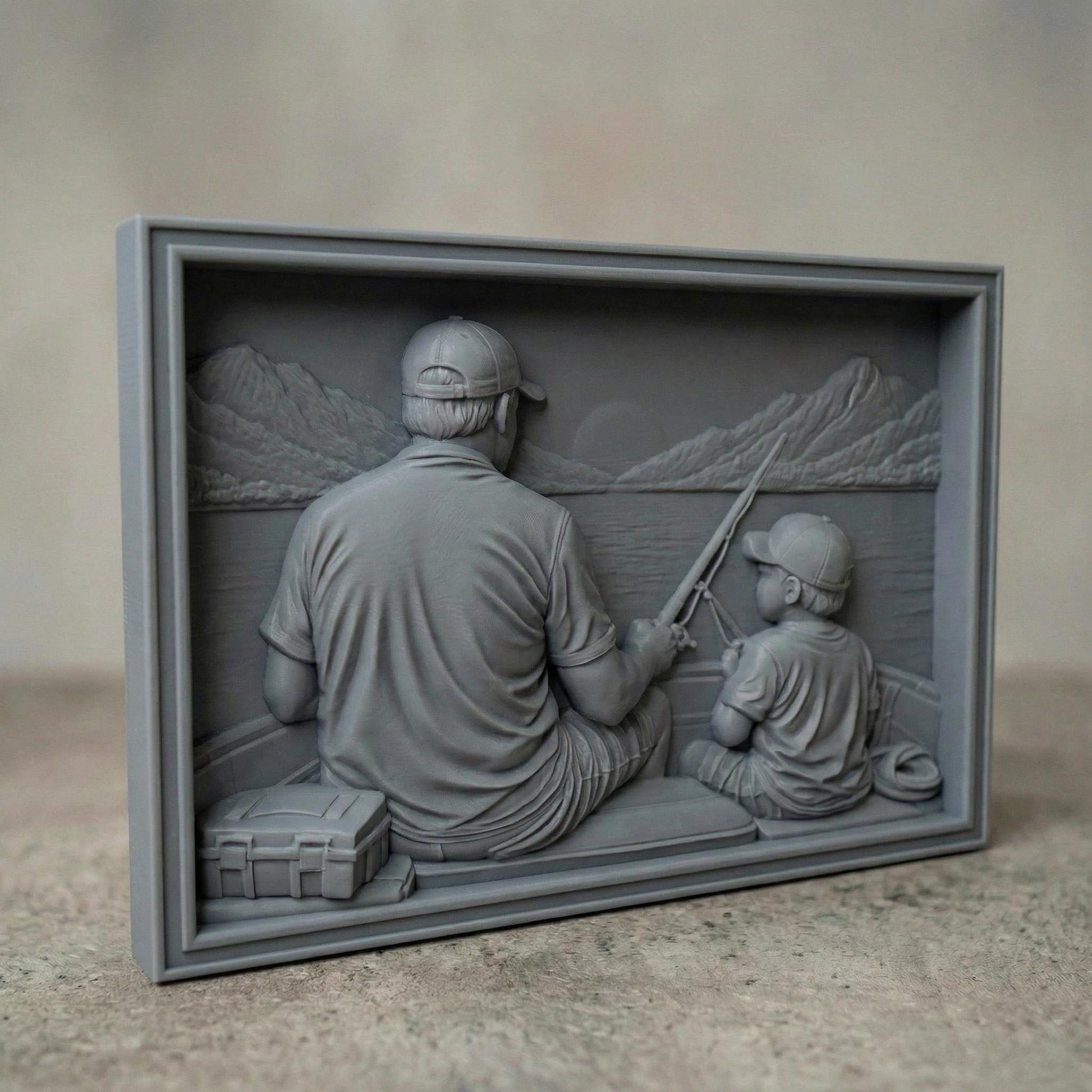 Bas relief carving of a father and young son sitting by a peaceful lake in spring, both wearing caps and smiling as they hold a fishing rod together. The father gently guides the child’s hands while casting toward calm water with a small boat in the distance. Framed square composition with detailed facial features, textured clothing, fresh grass, and serene springtime scenery, symbolizing bonding and outdoor family moments.