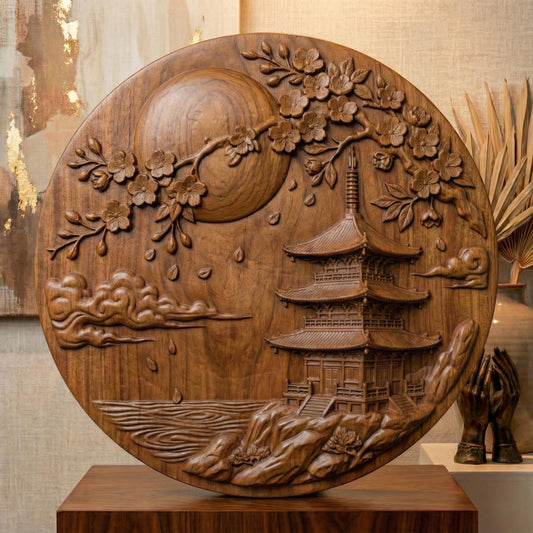 Round bas-relief panel depicting a traditional Japanese pagoda beside calm water under a large full moon. Flowing cherry blossom branches arch across the top with layered petals and falling blossoms. Soft carved clouds and textured landscape details create depth and serenity. The circular composition evokes balance and harmony, perfect for CNC carving, 3D printing, Zen décor, and Asian-inspired wall art.