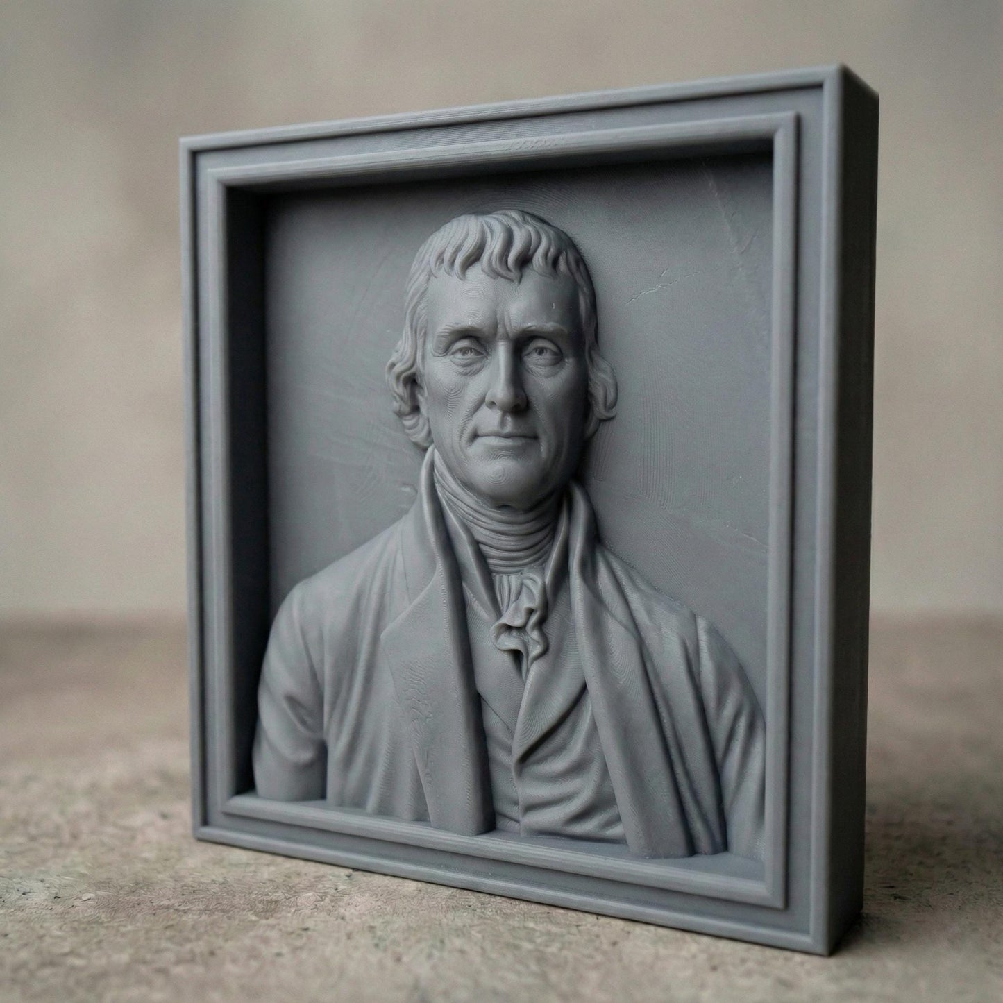 Highly detailed bas relief portrait of Thomas Jefferson carved in wood, framed in a classic square panel. The sculpture features refined facial contours, colonial-era clothing with cravat and coat, and natural wood grain texture enhancing depth and realism. Designed as a patriotic historical wall art piece ideal for CNC carving, 3D printing, and decorative relief projects.