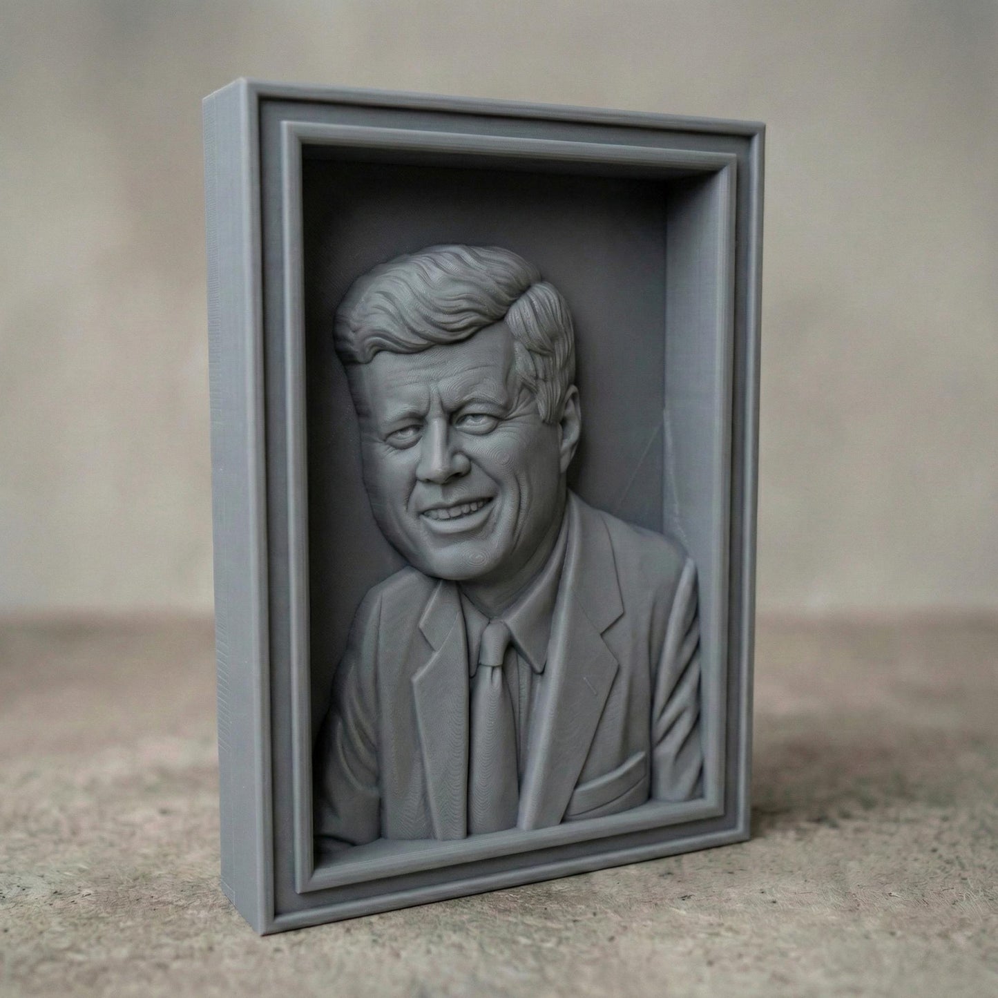 Detailed bas-relief portrait of a smiling mid-century president in a suit and tie, carved in rich wood texture with flowing hair strands, expressive eyes, and realistic facial contours. Displayed as both a freestanding bust on a workbench with carving tools and as a framed wall relief panel, evoking patriotism, leadership, and historic American legacy in a classic handcrafted style.