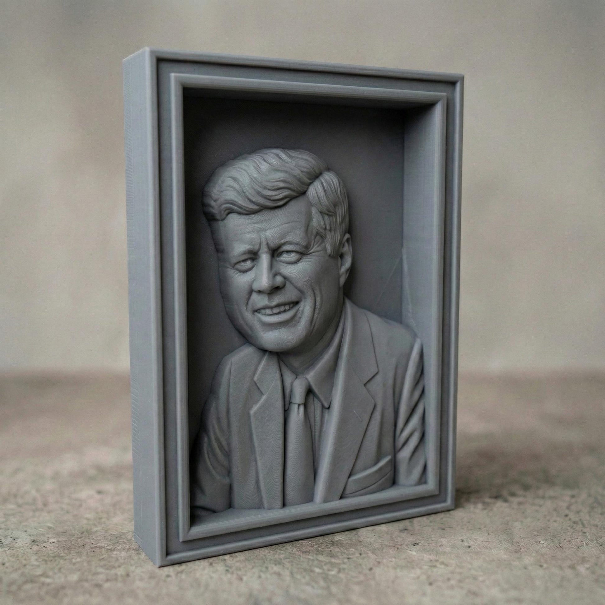 Detailed bas-relief portrait of a smiling mid-century president in a suit and tie, carved in rich wood texture with flowing hair strands, expressive eyes, and realistic facial contours. Displayed as both a freestanding bust on a workbench with carving tools and as a framed wall relief panel, evoking patriotism, leadership, and historic American legacy in a classic handcrafted style.