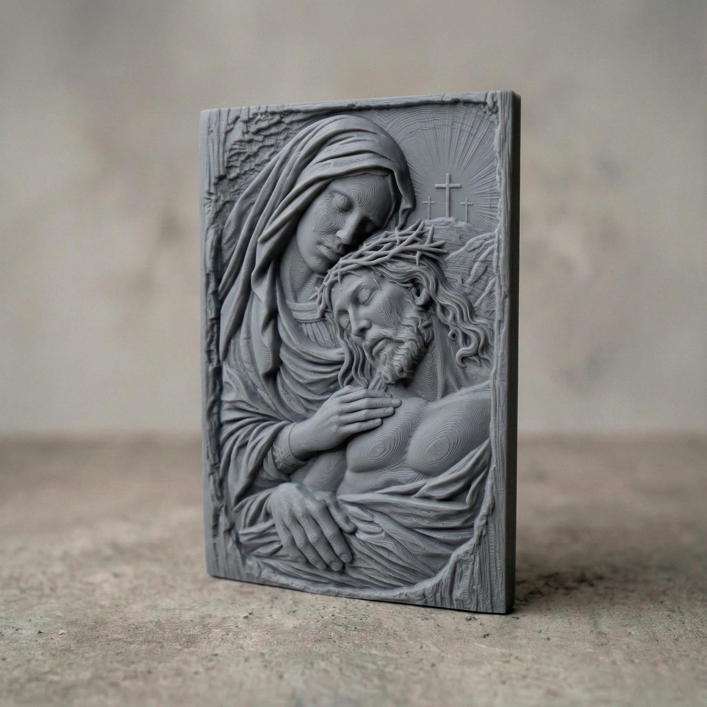 Highly detailed bas-relief sculpture of the Pietà showing the Virgin Mary gently holding the lifeless body of Jesus Christ after the crucifixion. Mary’s head rests tenderly against Jesus while tears fall from her face. Jesus wears a crown of thorns and appears peaceful. Three crosses rise in the background beneath radiant light, symbolizing Calvary. The composition features flowing robes, expressive anatomy, and deep relief ideal for CNC carving or 3D printing.