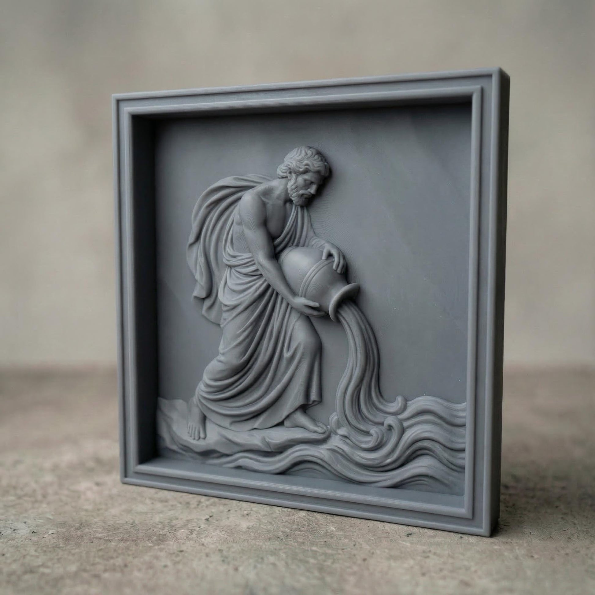 Classical bas-relief sculpture of the Aquarius water bearer carved in smooth marble style. A robed male figure with flowing drapery kneels while tilting a large amphora, pouring a stream of water that flows into stylized waves. The composition resembles ancient Greco-Roman relief art, emphasizing muscular anatomy, elegant cloth folds, and symbolic zodiac imagery associated with Aquarius and the element of water.