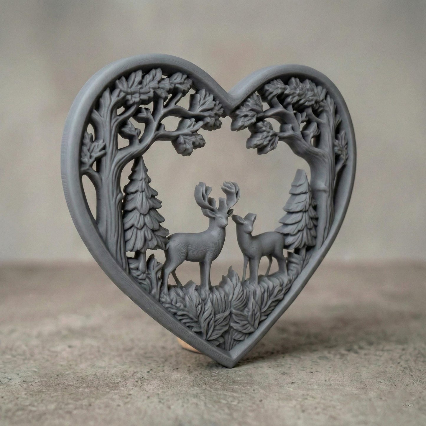 Heart-shaped woodland scene featuring a stag and doe standing together inside a forest frame of detailed oak trees and pine trees. The openwork design includes flowing branches and carved leaves surrounding the deer couple, symbolizing love, nature, family, and harmony. Designed as a decorative wall art panel for CNC carving and 3D printing with rich organic textures and rustic charm.
