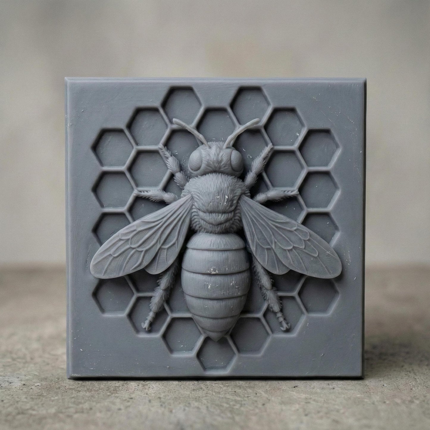 Detailed bas-relief sculpture of a honey bee centered on a hexagonal honeycomb background. The square panel features realistic wings, textured body, antennae, and symmetrical honeycomb cells carved behind the bee. Designed as decorative wall art with clean geometric framing, ideal for CNC carving or 3D printing projects with sharp detail and natural texture.