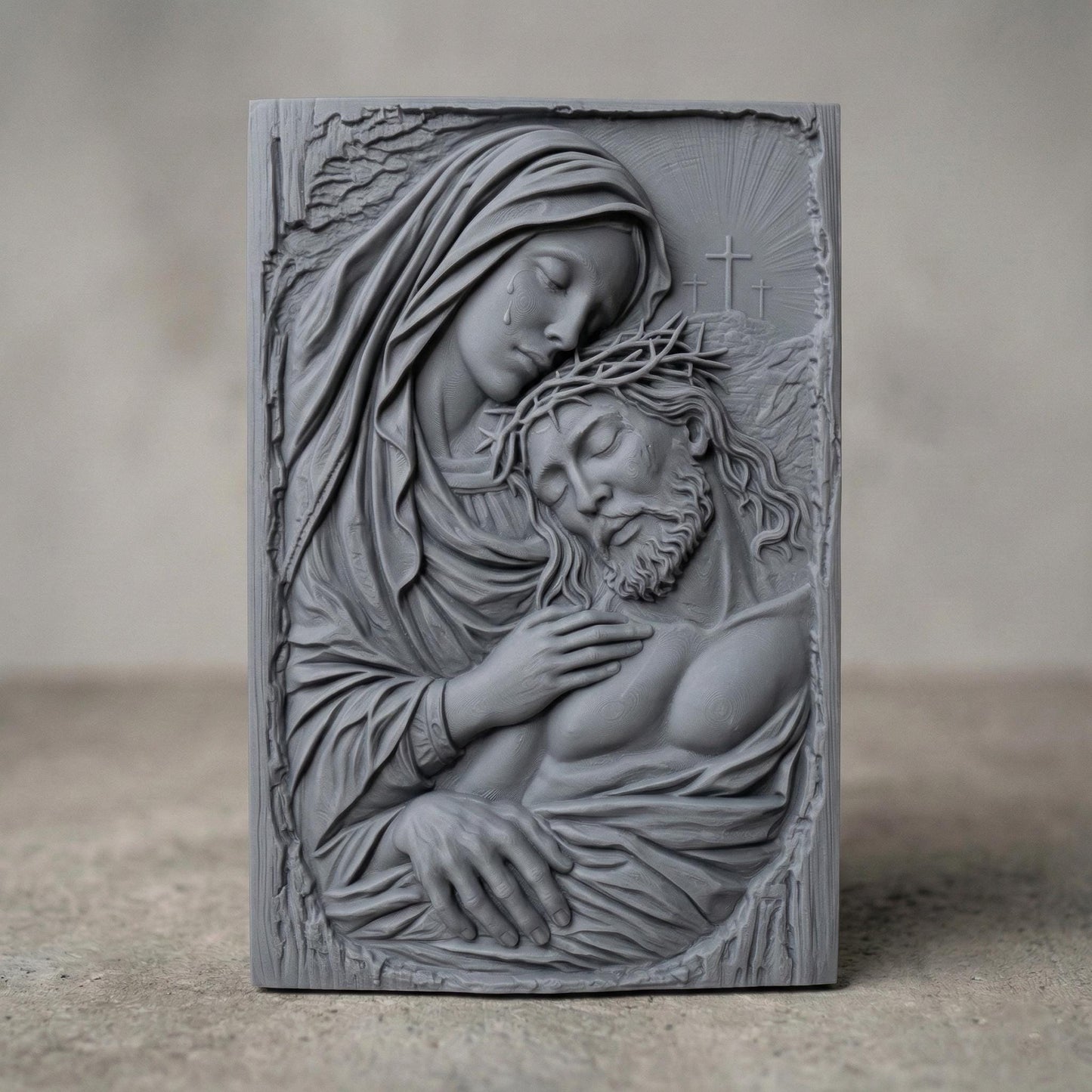Highly detailed bas-relief sculpture of the Pietà showing the Virgin Mary gently holding the lifeless body of Jesus Christ after the crucifixion. Mary’s head rests tenderly against Jesus while tears fall from her face. Jesus wears a crown of thorns and appears peaceful. Three crosses rise in the background beneath radiant light, symbolizing Calvary. The composition features flowing robes, expressive anatomy, and deep relief ideal for CNC carving or 3D printing.
