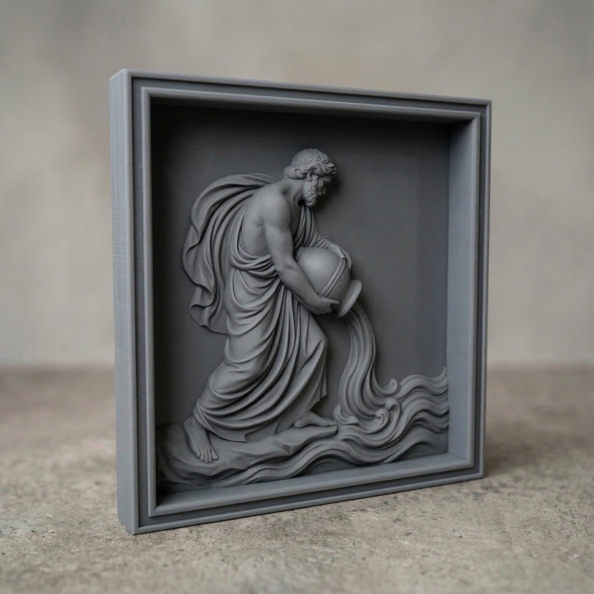 Classical bas-relief sculpture of the Aquarius water bearer carved in smooth marble style. A robed male figure with flowing drapery kneels while tilting a large amphora, pouring a stream of water that flows into stylized waves. The composition resembles ancient Greco-Roman relief art, emphasizing muscular anatomy, elegant cloth folds, and symbolic zodiac imagery associated with Aquarius and the element of water.