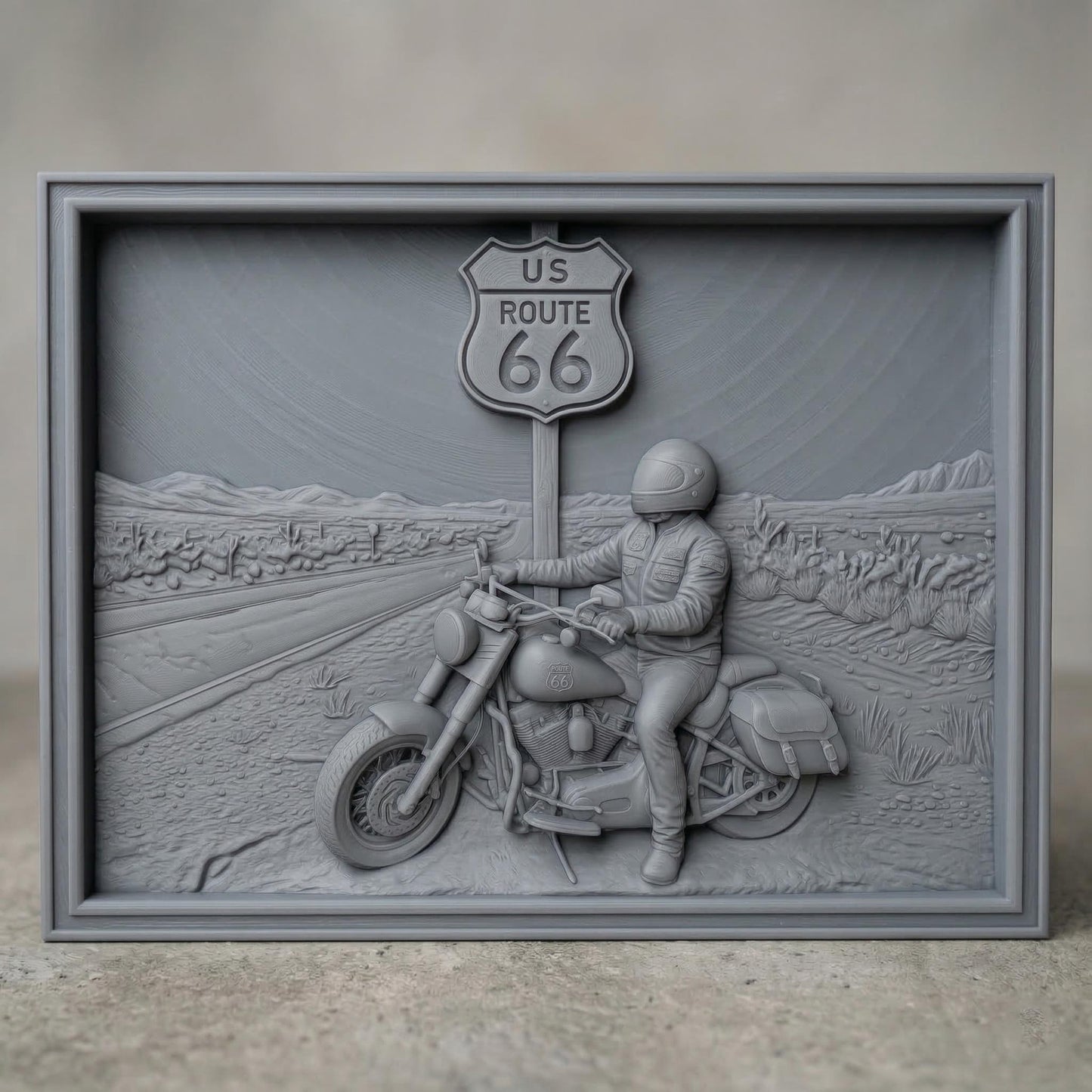 Detailed bas-relief scene of a motorcycle rider parked beside a US Route 66 road sign in a desert highway landscape. The rider wears a helmet and leather riding gear while sitting on a classic touring motorcycle with saddlebags. The background shows an open road stretching through desert terrain with cacti and distant mountains, symbolizing freedom, adventure, and the iconic American road trip culture.