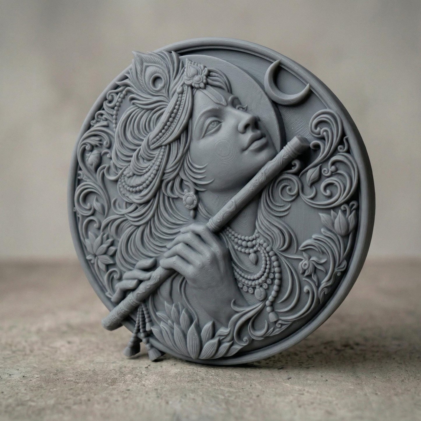 Highly detailed circular bas-relief carving of Lord Krishna playing the flute, adorned with ornate jewelry and flowing hair. A peacock feather crowns the head while a crescent moon appears in the background. Intricate floral patterns and smooth wood grain textures enhance the divine, serene expression, symbolizing peace, devotion, and spiritual harmony.