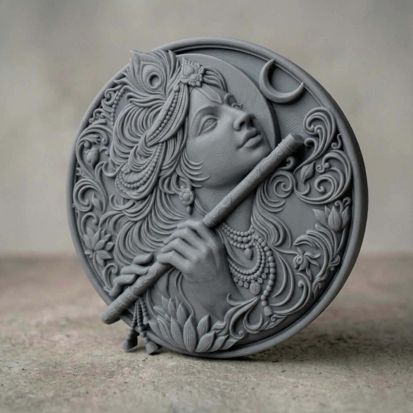 Highly detailed circular bas-relief carving of Lord Krishna playing the flute, adorned with ornate jewelry and flowing hair. A peacock feather crowns the head while a crescent moon appears in the background. Intricate floral patterns and smooth wood grain textures enhance the divine, serene expression, symbolizing peace, devotion, and spiritual harmony.