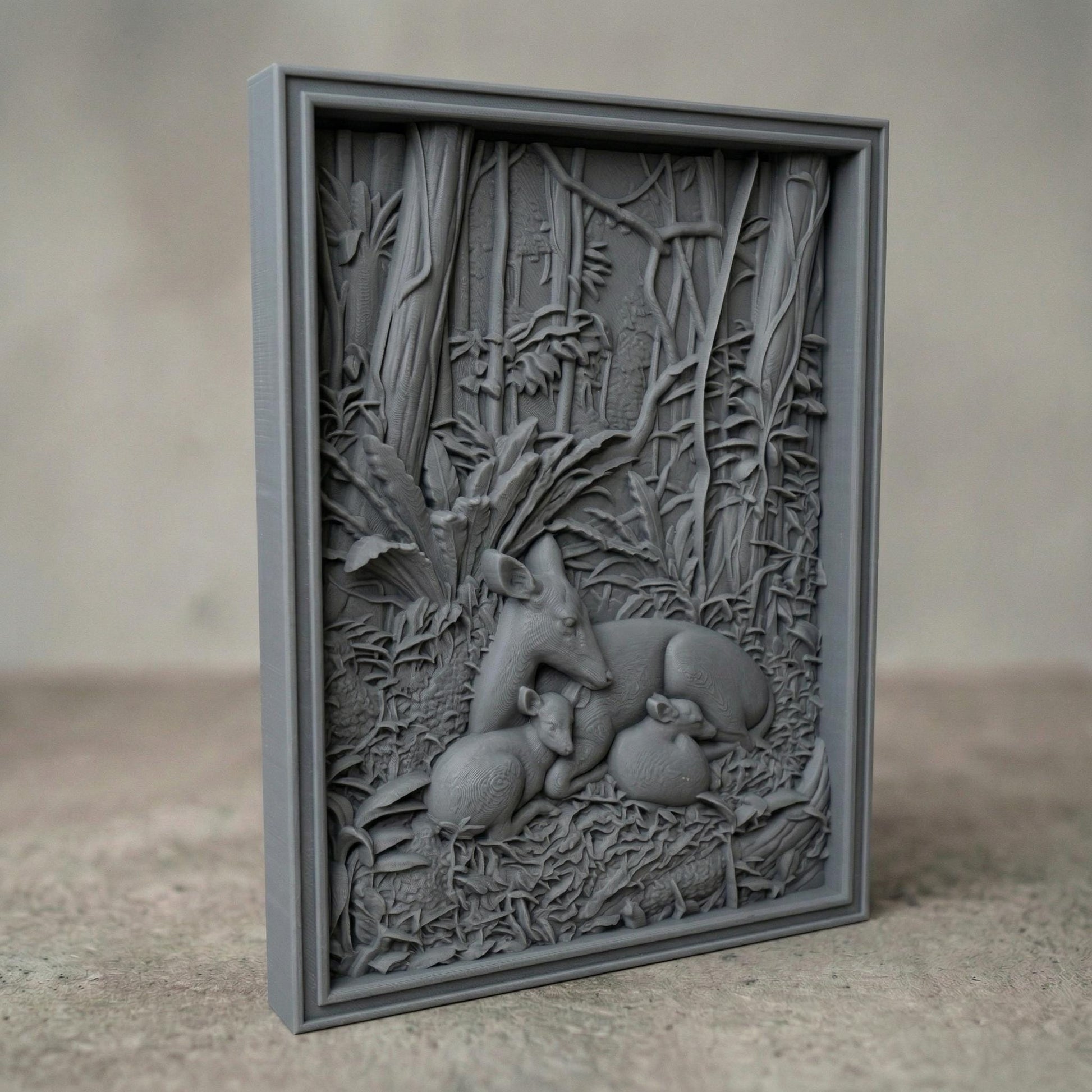 Detailed bas-relief carving of a deer resting peacefully with two fawns nestled beside it in a dense forest setting, surrounded by lush foliage, textured leaves, and tall trees, capturing warmth, protection, and tranquility in a natural woodland scene.