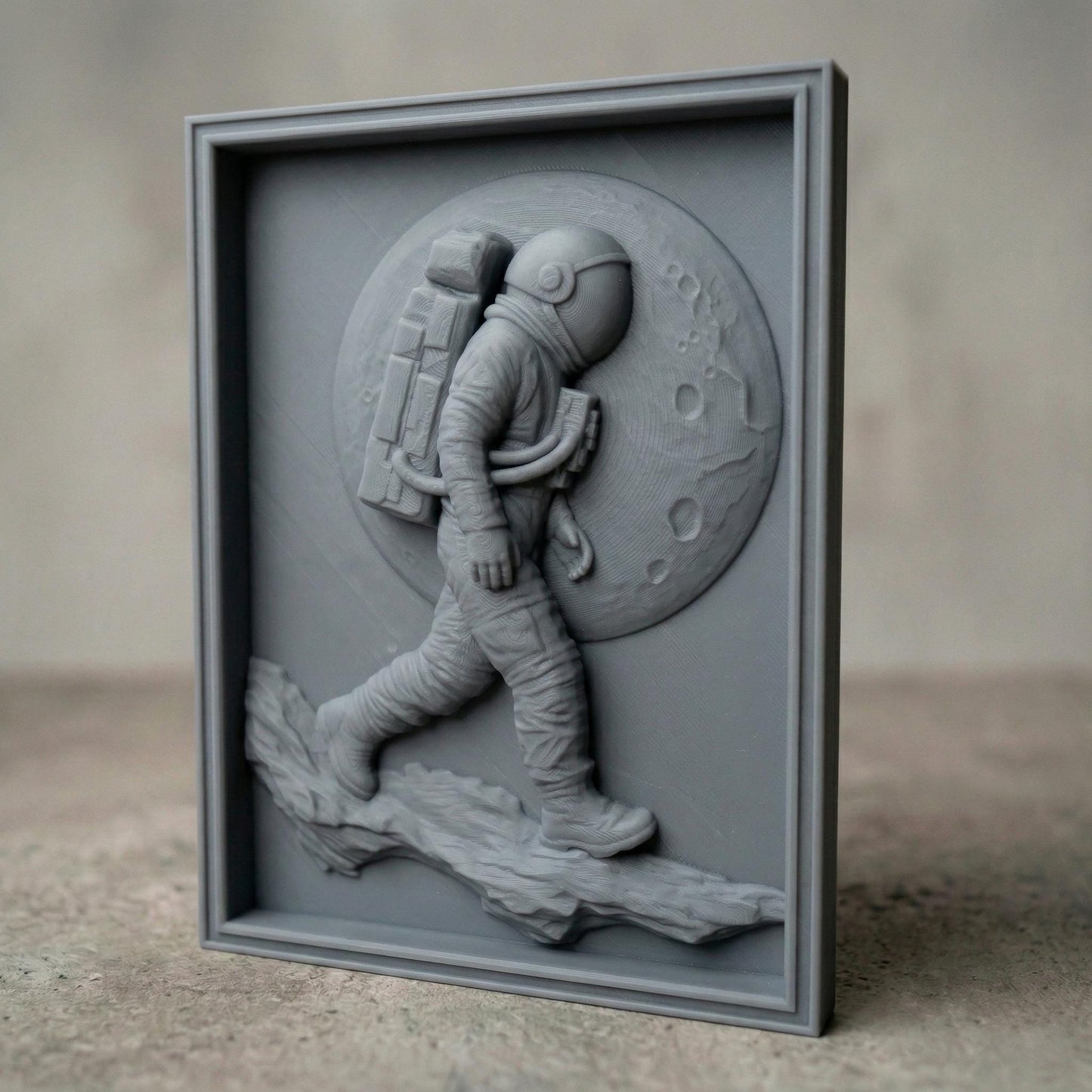 Detailed bas-relief carving of an astronaut walking across a rocky lunar surface with a large cratered moon behind. The figure wears a full space suit with backpack and helmet, captured mid-step in a futuristic exploration scene. Rich wood grain texture and depth create a bold, adventurous composition symbolizing discovery and space travel.