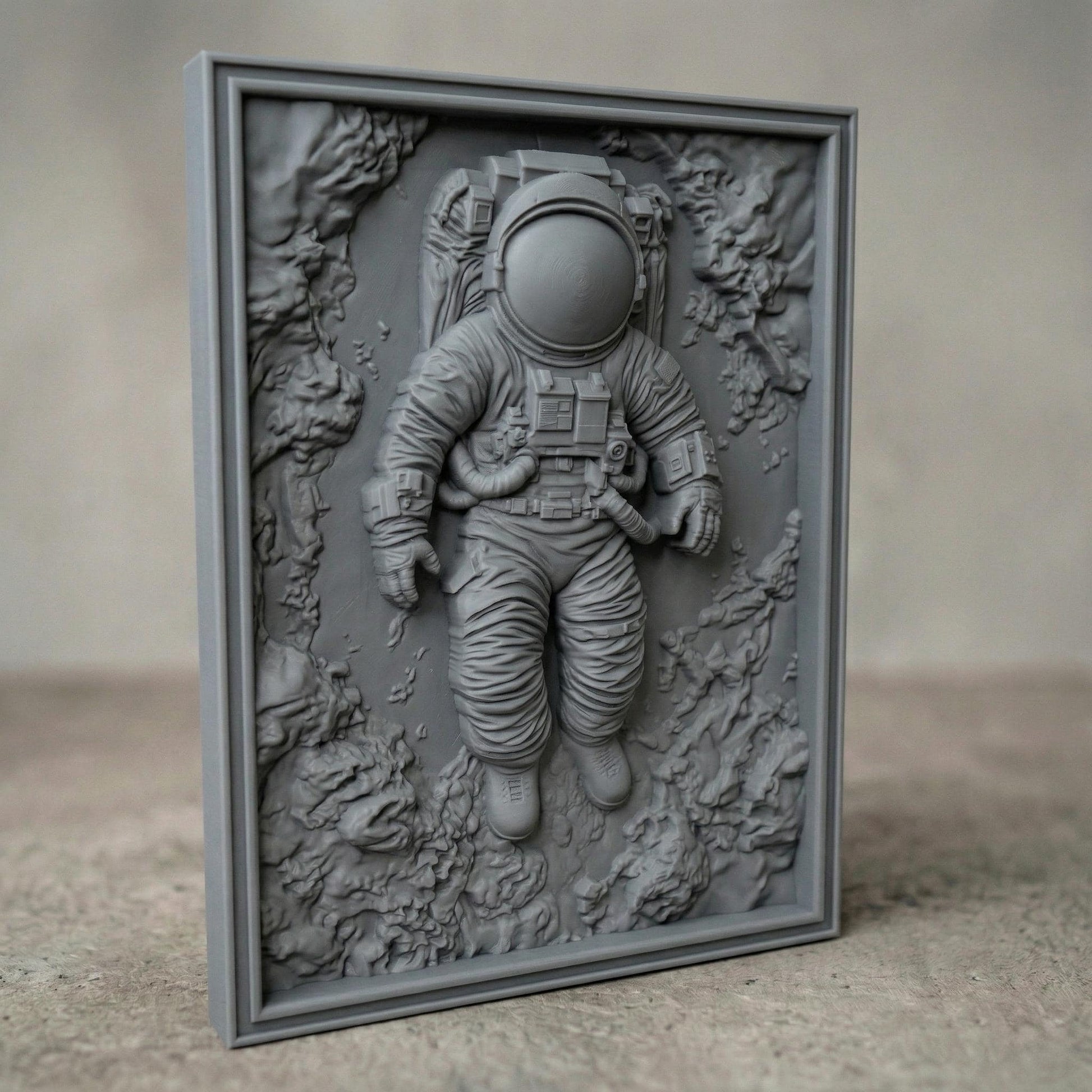 Intricate bas-relief carving of an astronaut floating weightlessly in space, surrounded by textured cosmic rock formations and abstract celestial terrain. The detailed suit, helmet, and tubing contrast with the organic, flowing background, while rich wood grain enhances depth and movement, evoking isolation, exploration, and the vast mystery of the universe.