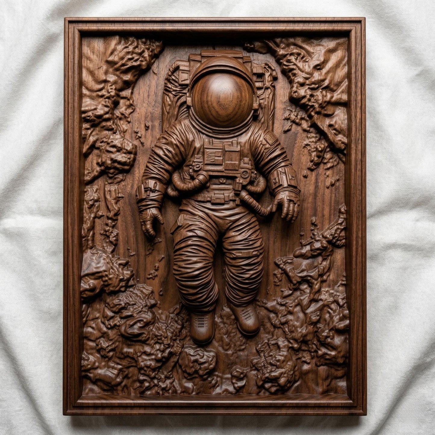 Intricate bas-relief carving of an astronaut floating weightlessly in space, surrounded by textured cosmic rock formations and abstract celestial terrain. The detailed suit, helmet, and tubing contrast with the organic, flowing background, while rich wood grain enhances depth and movement, evoking isolation, exploration, and the vast mystery of the universe.