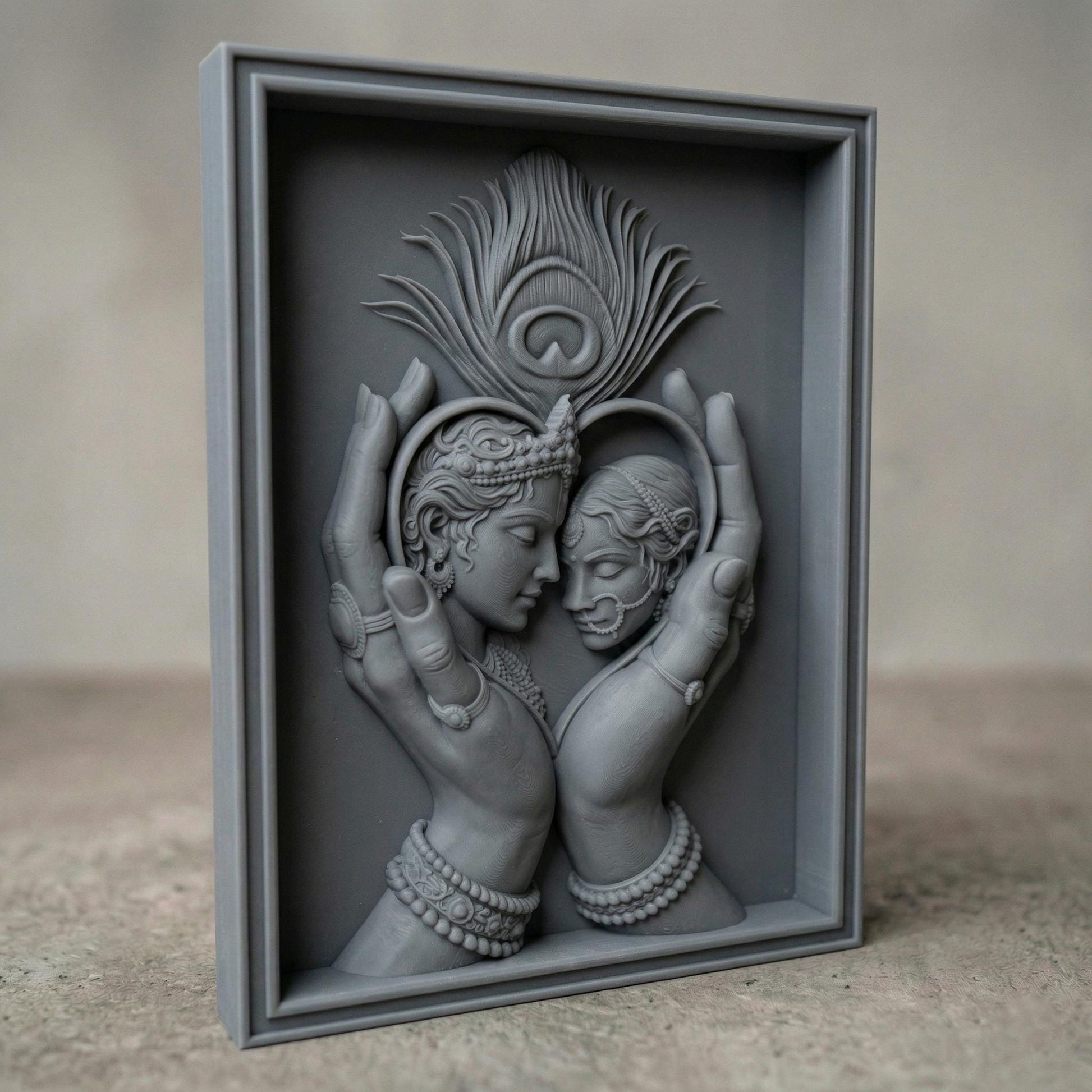 Intricately carved bas-relief of Radha and Krishna in an intimate embrace, framed by graceful hands forming a heart shape. A detailed peacock feather rises above, symbolizing divine love and harmony. Ornate jewelry, flowing hair, and smooth wood grain textures enhance the spiritual and romantic essence of this elegant composition.