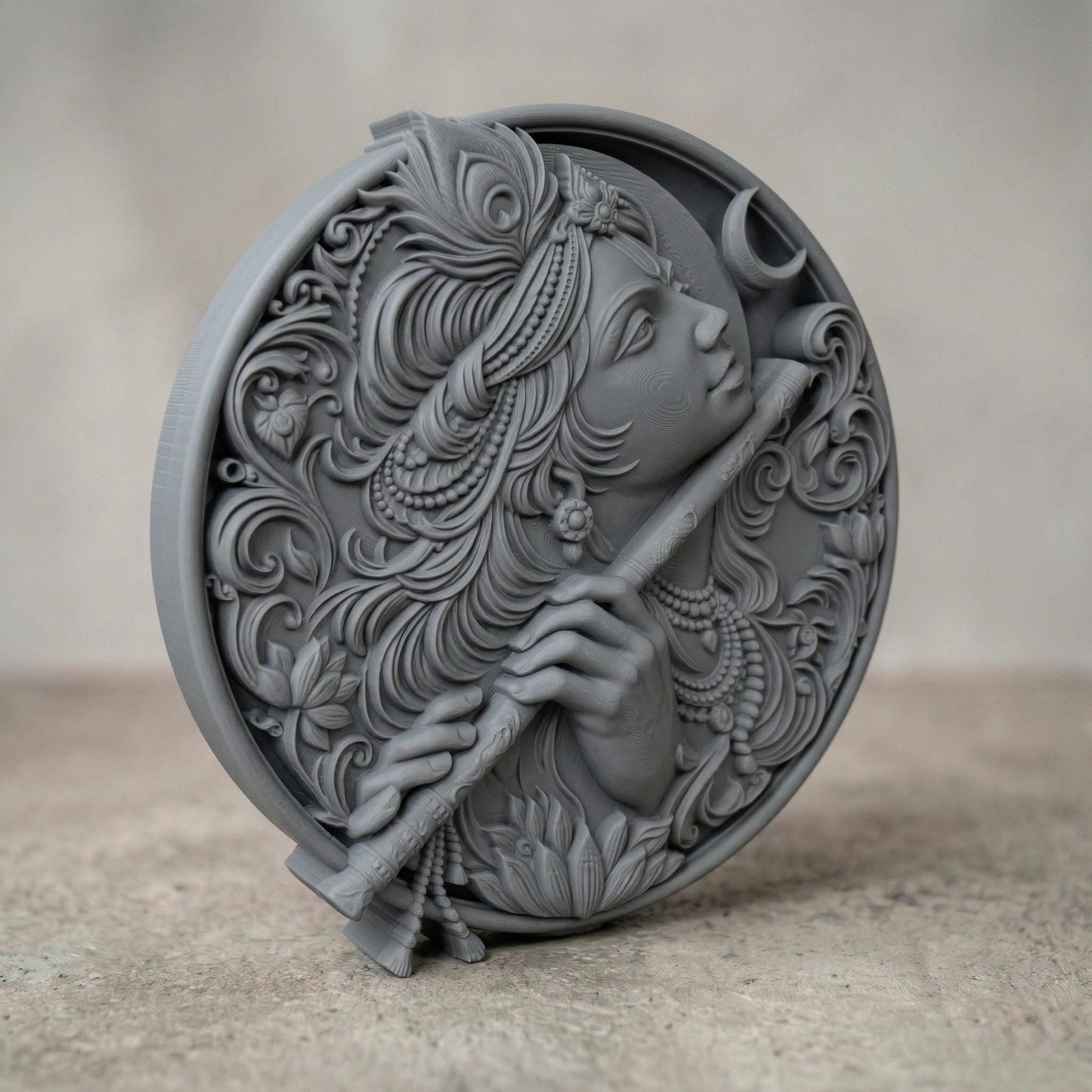 Highly detailed circular bas-relief carving of Lord Krishna playing the flute, adorned with ornate jewelry and flowing hair. A peacock feather crowns the head while a crescent moon appears in the background. Intricate floral patterns and smooth wood grain textures enhance the divine, serene expression, symbolizing peace, devotion, and spiritual harmony.