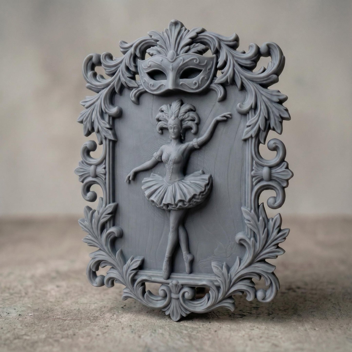 Ornate bas-relief featuring a graceful ballerina in mid-dance pose, framed by intricate baroque scrollwork and topped with a decorative Venetian carnival mask. The dancer wears a detailed tutu and feathered headpiece, symbolizing elegance and theatrical beauty, ideal for CNC carving or 3D printing refined wall decor.