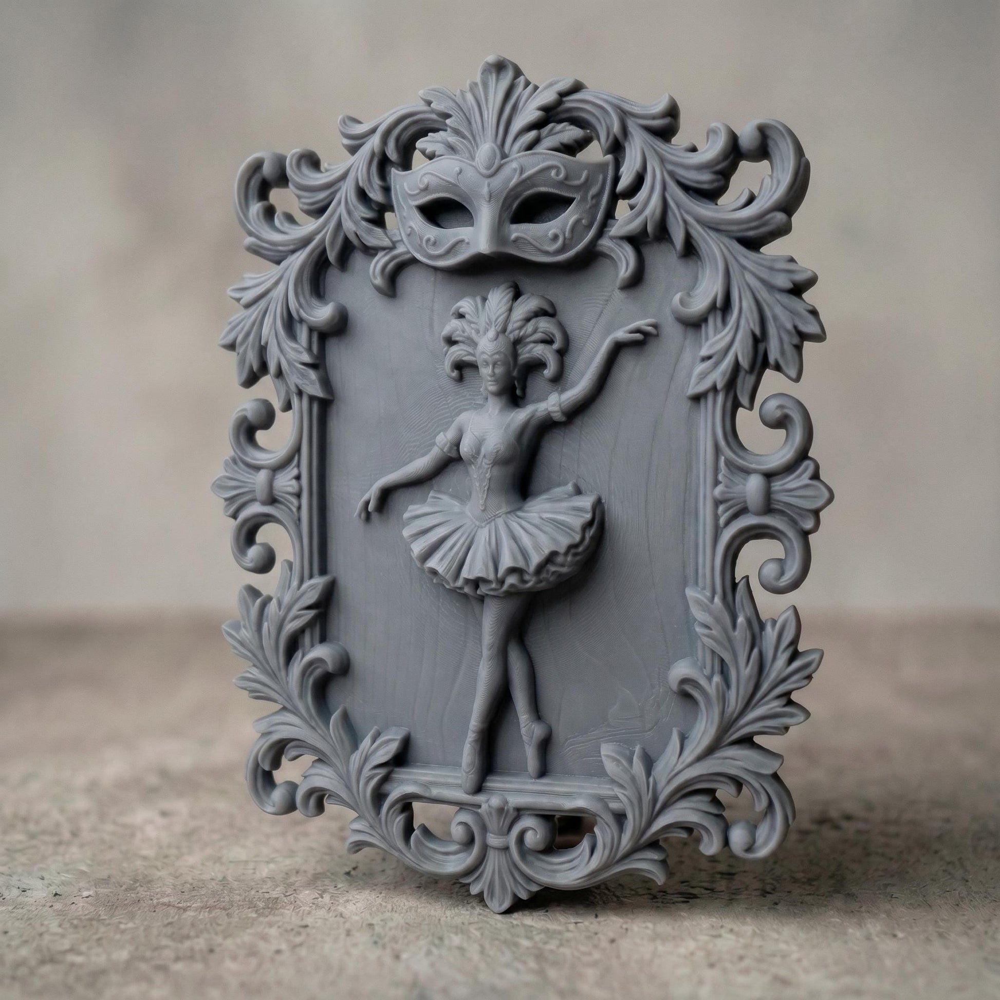 Ornate bas-relief featuring a graceful ballerina in mid-dance pose, framed by intricate baroque scrollwork and topped with a decorative Venetian carnival mask. The dancer wears a detailed tutu and feathered headpiece, symbolizing elegance and theatrical beauty, ideal for CNC carving or 3D printing refined wall decor.