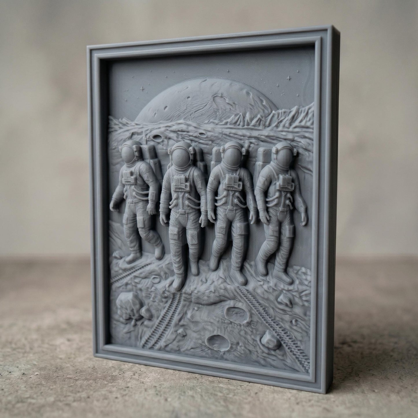 Detailed bas-relief carving of four astronauts walking across a lunar surface with visible craters and rover tracks, set against a large planetary horizon and rugged terrain, framed in a rectangular wooden panel. The figures wear full space suits with helmets and backpacks, captured in motion with realistic depth and texture, evoking space exploration and teamwork.