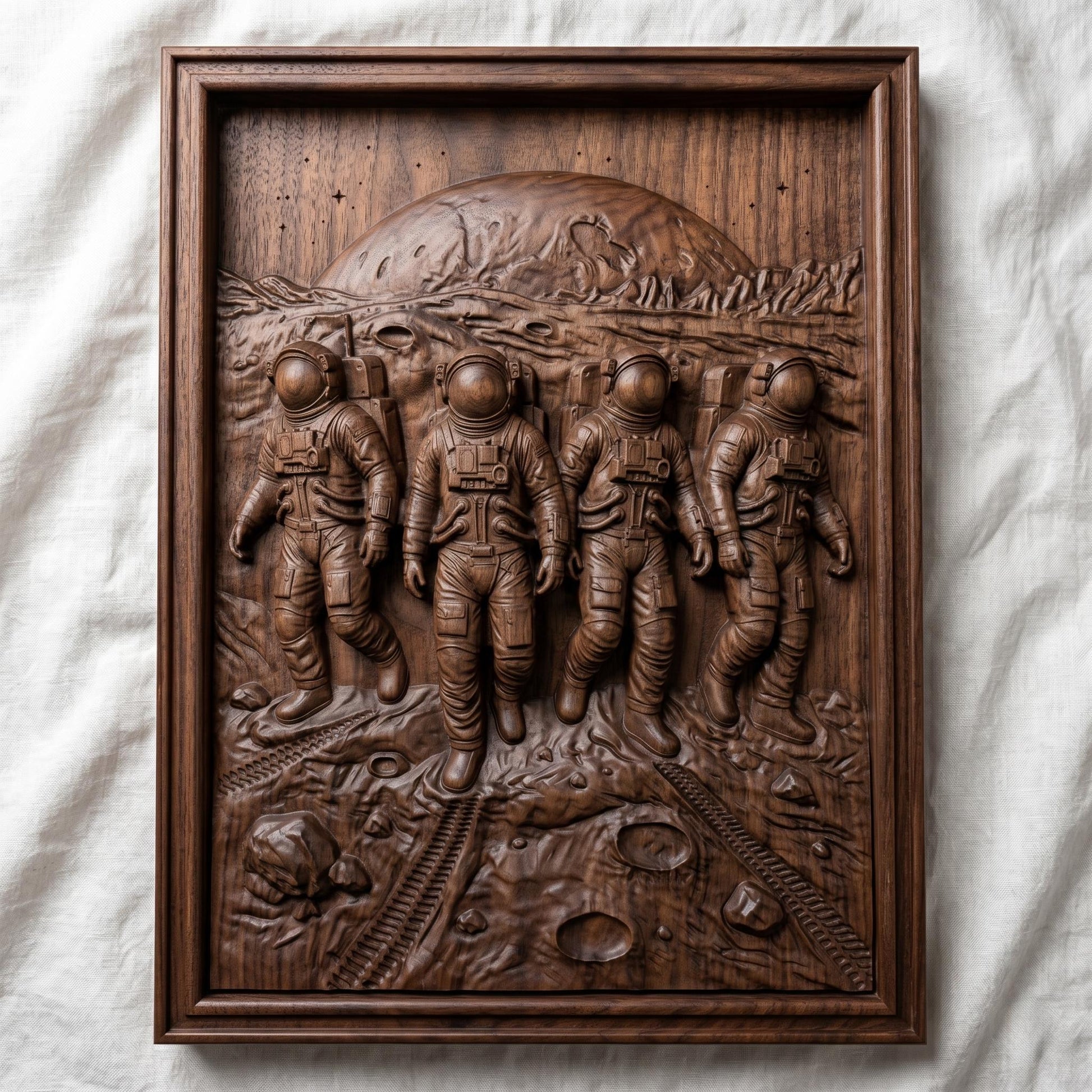 Detailed bas-relief carving of four astronauts walking across a lunar surface with visible craters and rover tracks, set against a large planetary horizon and rugged terrain, framed in a rectangular wooden panel. The figures wear full space suits with helmets and backpacks, captured in motion with realistic depth and texture, evoking space exploration and teamwork.