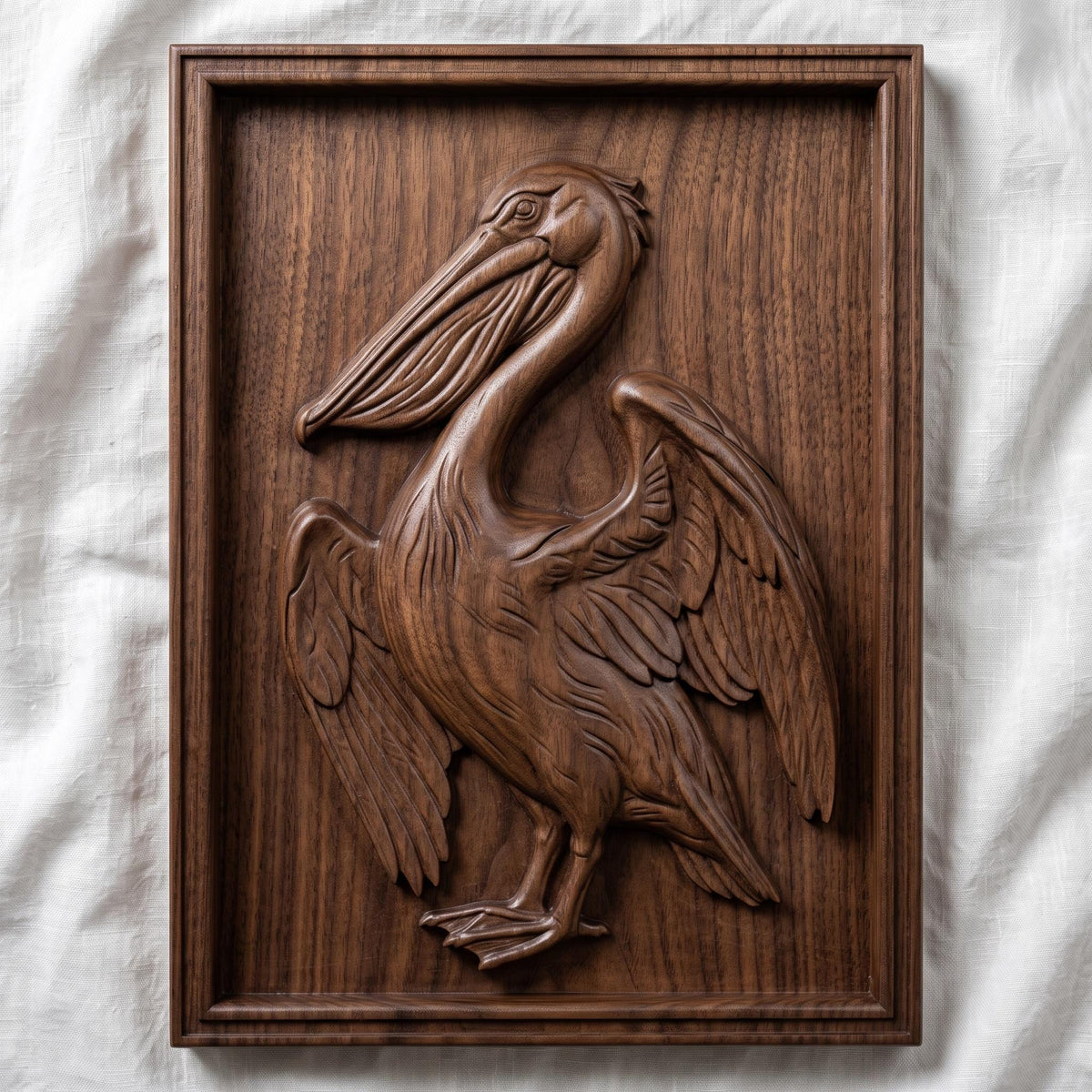 Detailed 3D bas-relief of a pelican standing with wings partly spread, long hooked bill and pouched throat, feather detail across the wings and breast. Carved in rich walnut wood grain and set within a raised rectangular frame border. Designed for CNC relief carving, wood routing, resin casting, and 3D printing as coastal wall decor.