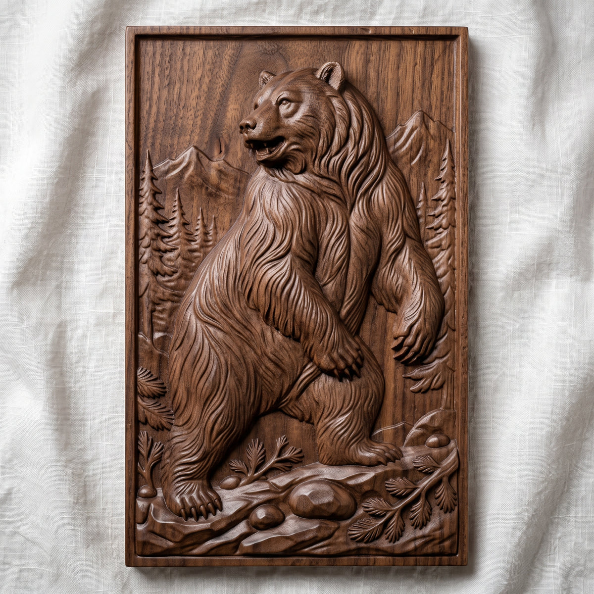 Detailed 3D bas-relief of a standing grizzly bear in a pine forest with snow-capped mountains behind, rocky ground and fern details in the foreground. Framed by a rectangular molded border around a recessed panel. Shown in carved walnut wood and grey resin. Designed for CNC relief carving, woodworking and 3D printing as rustic cabin and wildlife wall decor.