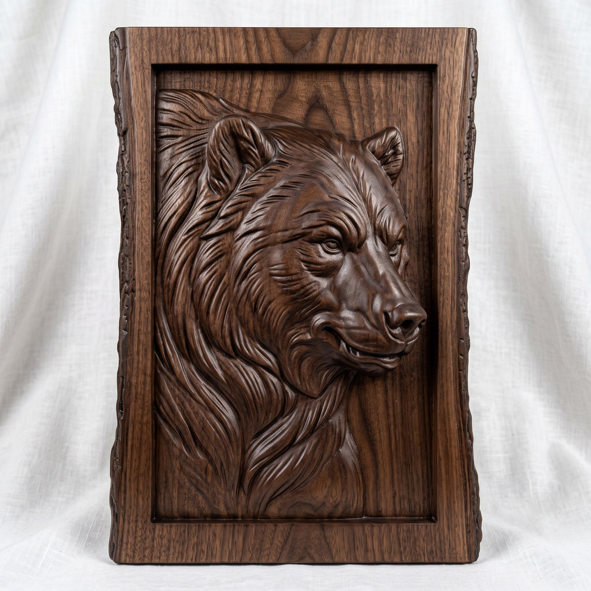 Detailed 3D bas-relief of a bear head in side profile with thick flowing fur, alert eyes and rounded ears, set inside a recessed panel. Framed by a rustic live edge wood border with natural bark texture and a raised inner rim. Shown in carved walnut wood and grey resin. Designed for CNC relief carving, woodworking and 3D printing as rustic cabin wildlife wall decor.