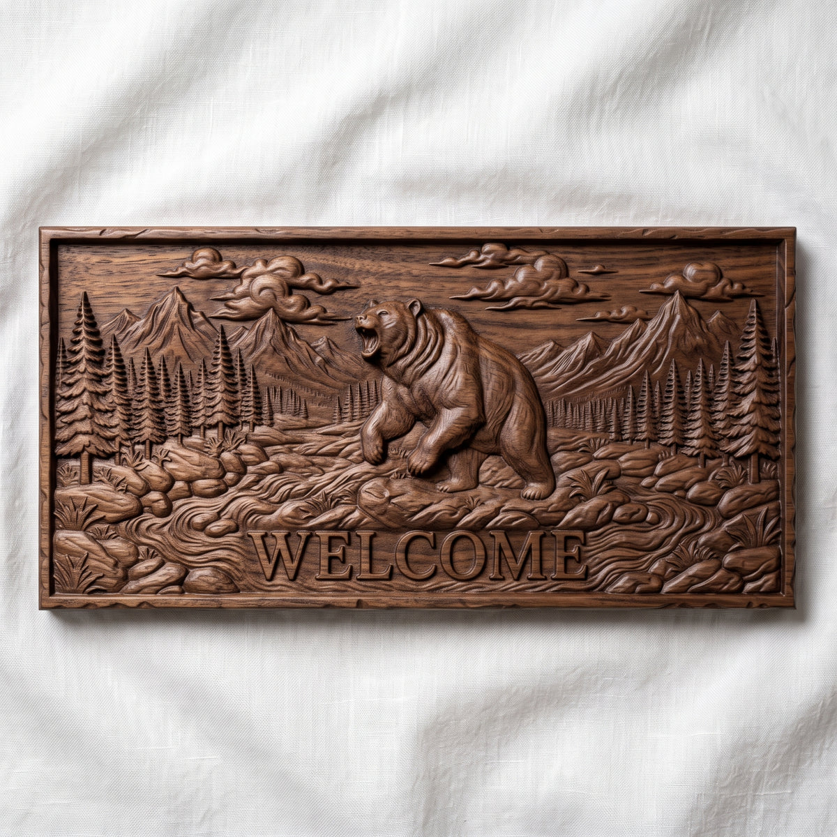 Detailed 3D bas-relief of a roaring grizzly bear standing on its hind legs in a mountain valley, with WELCOME lettering carved below. Pine forest, rocky stream, rugged peaks and billowing clouds fill the scene on a rectangular slab with a rough stone-style edge. Fine fur texture. Designed for CNC relief carving, woodworking and 3D printing as rustic cabin and porch wall decor.