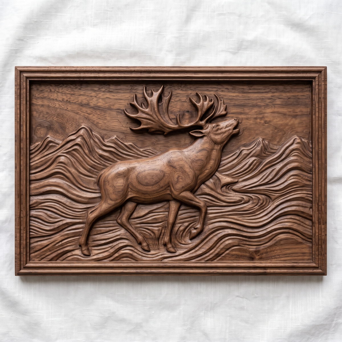 Detailed 3D bas-relief of a caribou with large branching antlers and raised front leg, striding through layered mountain ridges and flowing wind-swept waves. Set in a rectangular panel with a stepped molded frame, shown in carved walnut wood. Designed for CNC relief carving, woodworking and 3D printing as rustic northern wildlife wall decor.