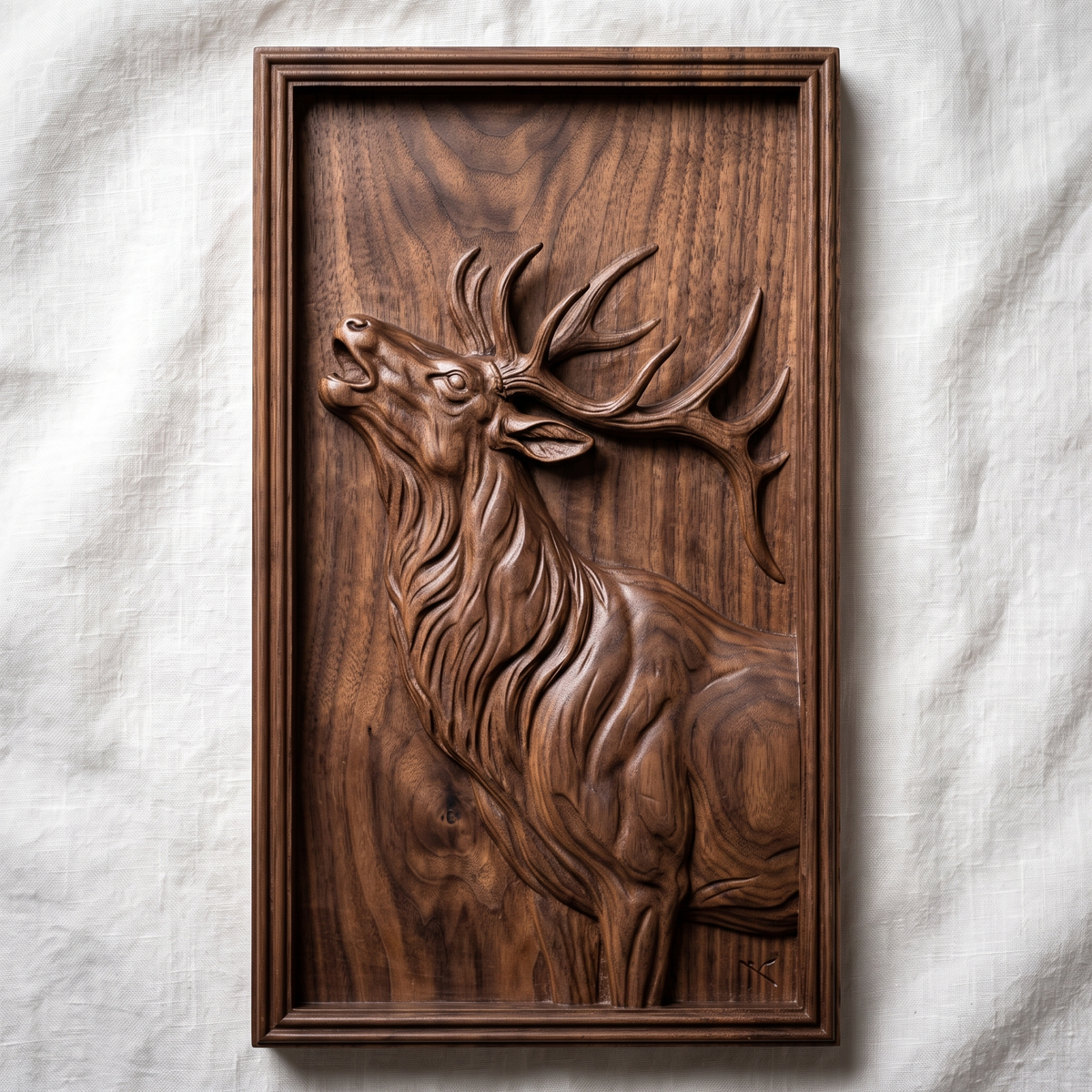Detailed 3D bas-relief of a bull elk in side profile with head raised, large branching antlers, flowing mane and fine fur texture. Set in a rectangular panel with a stepped molded frame, shown in carved walnut wood. Designed for CNC relief carving, woodworking and 3D printing as rustic wildlife wall decor.