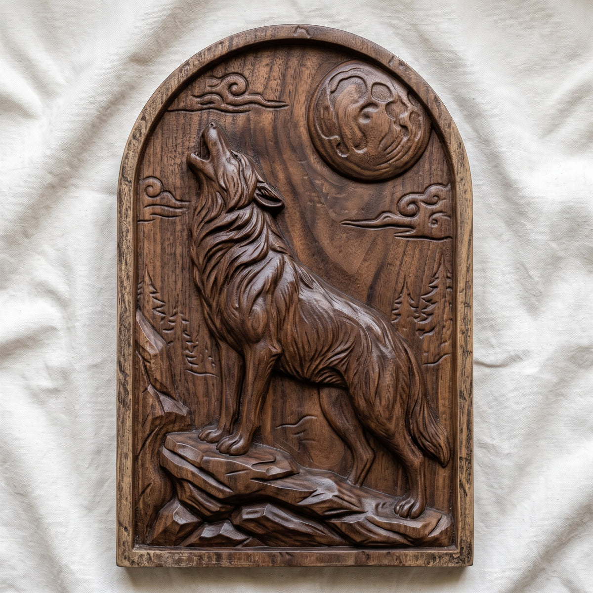 Detailed 3D bas-relief of a wolf howling at a full moon, standing on a rocky ledge with deep fur texture, swirling clouds, pine trees and mountain rocks behind. The scene is carved on an arched-top panel with a thin raised border and rustic wood grain. Designed for CNC router carving, wood routing and 3D printing as wolf wall decor for a cabin or lodge.