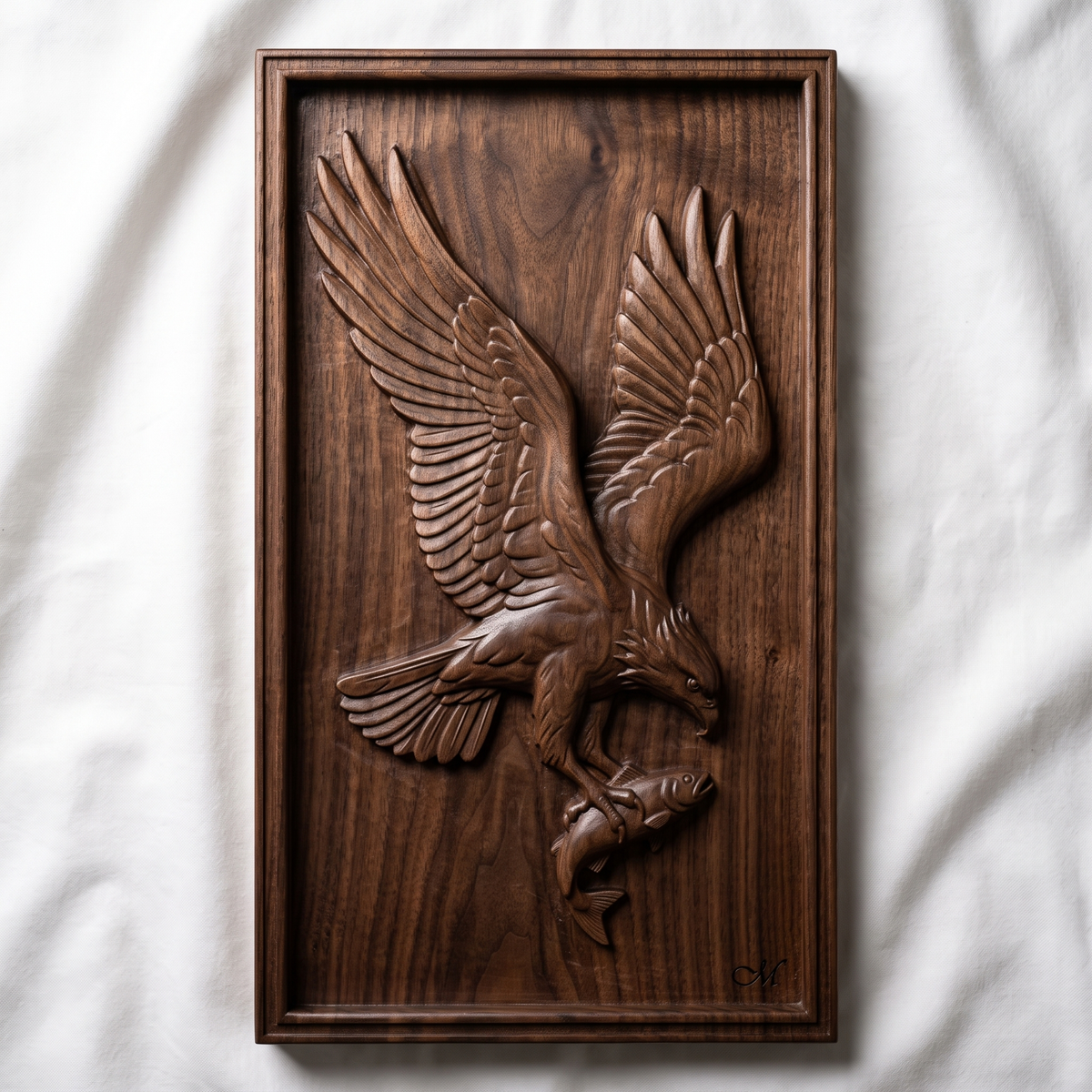 Highly detailed 3D bas-relief of a bald eagle diving with wings raised and spread wide, talons gripping a fish, head turned down toward its catch, carved in rich walnut wood. Framed by a raised, molded picture-frame border on a vertical rectangular panel. Fine relief carving captures individual feather barbs, fish scales, and natural wood grain. Designed for CNC relief carving, wood routing, and 3D printing as wildlife, lodge, or patriotic wall decor.