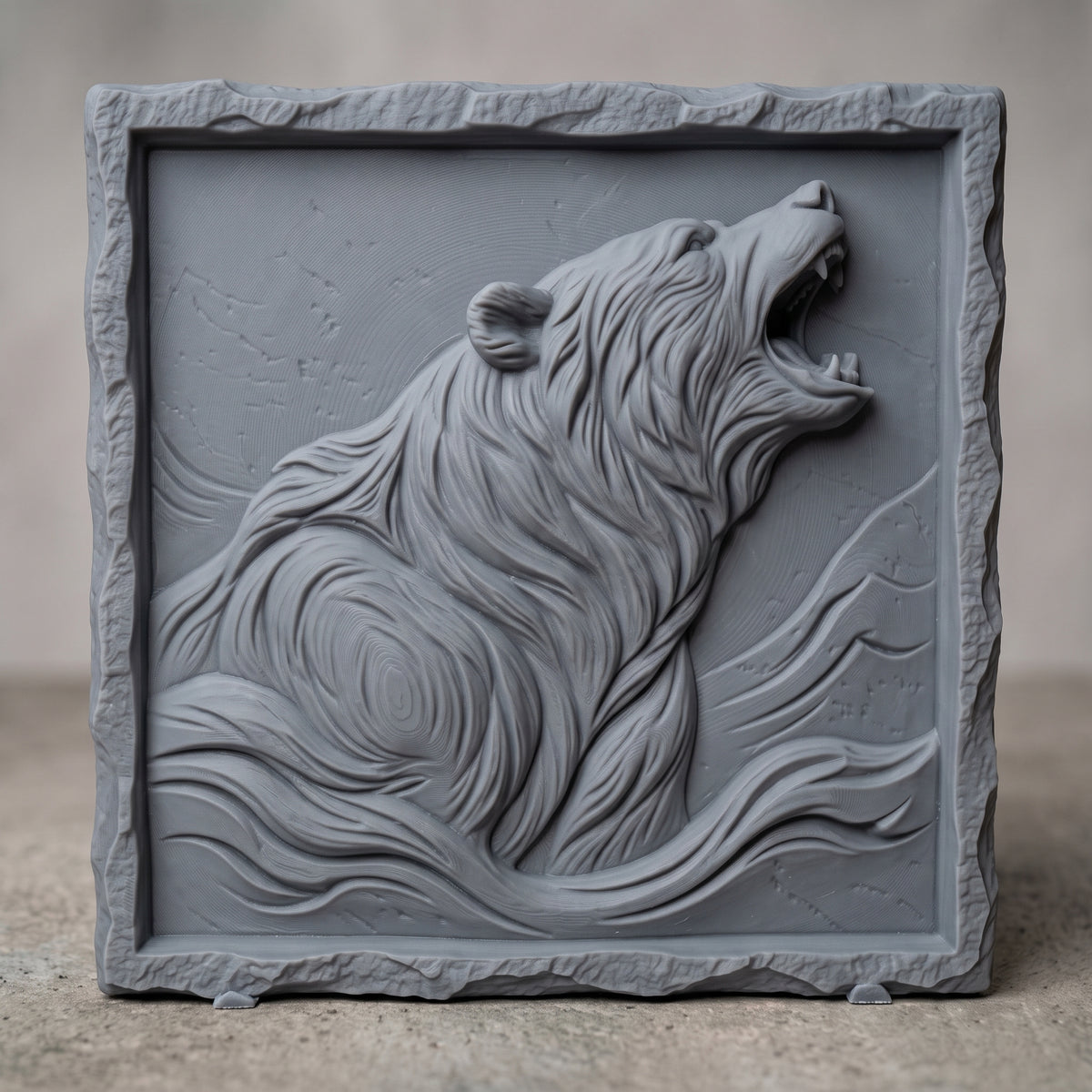 Detailed 3D bas-relief of a roaring bear with head raised and mouth open, thick flowing fur and mountain ridges behind. Set in a square panel with a rough hewn stone style border around a recessed field. Shown in carved walnut wood and grey resin. Designed for CNC relief carving, woodworking and 3D printing as rustic cabin and wildlife wall decor.