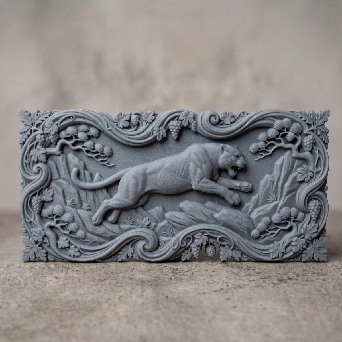 Leaping mountain lion carved in dark walnut wood as a cutout with a scrolling vine, grape and pine branch border and leaf corners, shown as a workshop mockup and a grey resin render. Digital STL relief file for CNC routers and 3D printers, ideal for wildlife wall art, panels and woodworking projects.