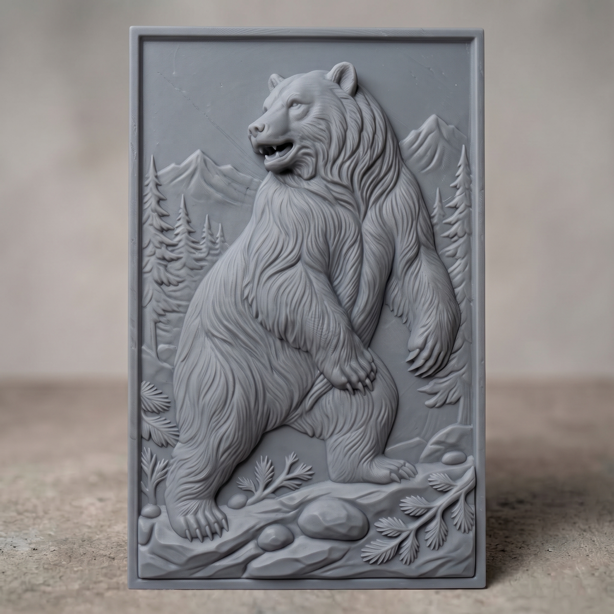 Detailed 3D bas-relief of a standing grizzly bear with thick flowing fur and an open mouth, set against snow-capped mountains and tall pine trees on a rectangular panel with rocks and fern branches at its feet. Shown in carved walnut wood and grey resin. Designed for CNC relief carving, woodworking and 3D printing as rustic cabin wildlife wall decor.