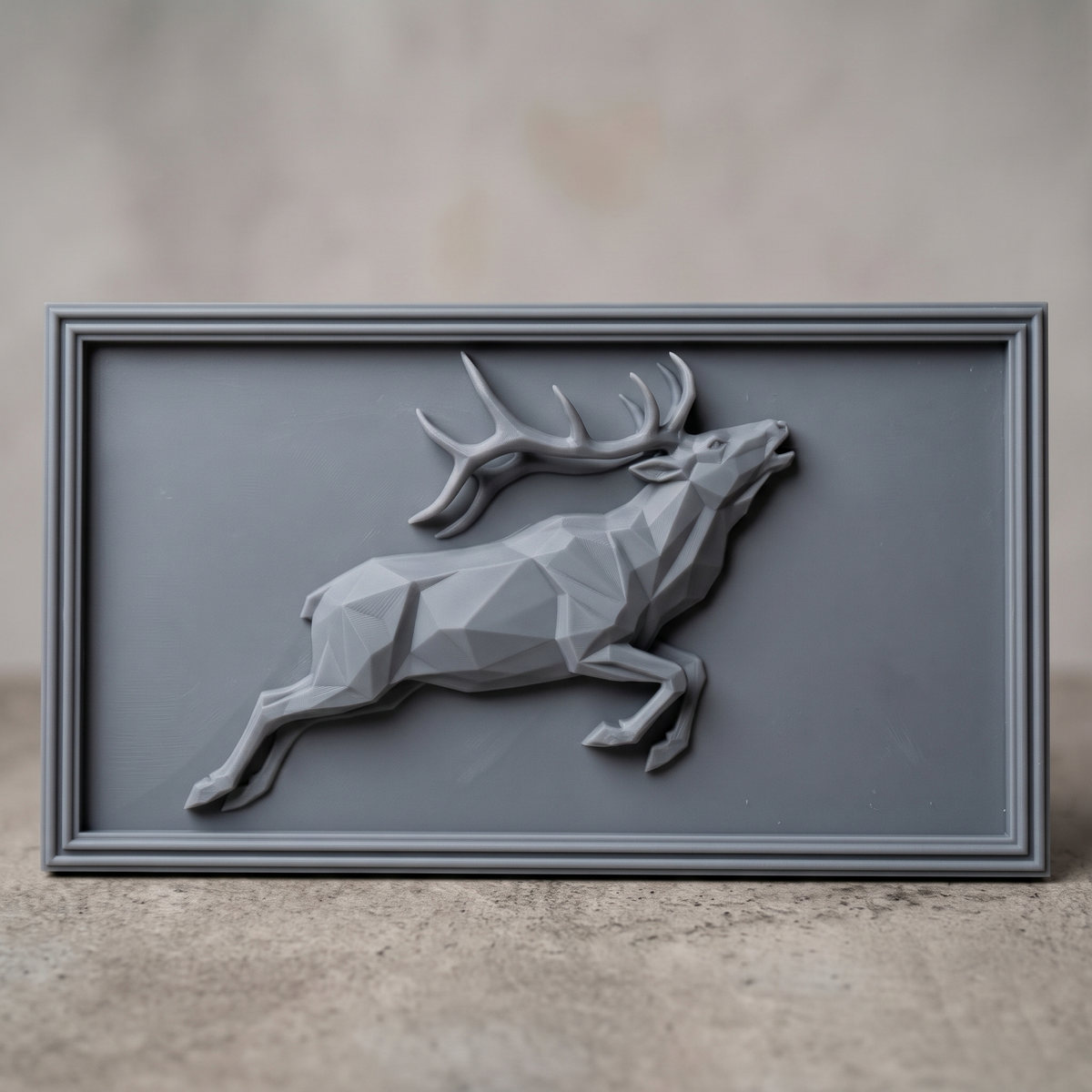Detailed 3D bas-relief of a low poly geometric bull elk leaping with head raised and large antlers, faceted angular body and raised hooves, set inside a stepped molded rectangular frame. Shown in carved walnut wood and grey resin. Designed for CNC relief carving, woodworking and 3D printing as modern geometric wildlife wall decor.