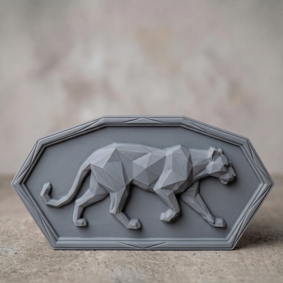 Low poly mountain lion carved in dark walnut wood inside a chamfered rectangular frame with stepped raised border, shown as a workshop mockup and a grey resin render. Digital STL relief file for CNC routers and 3D printers, ideal for wildlife wall art, panels and woodworking projects.