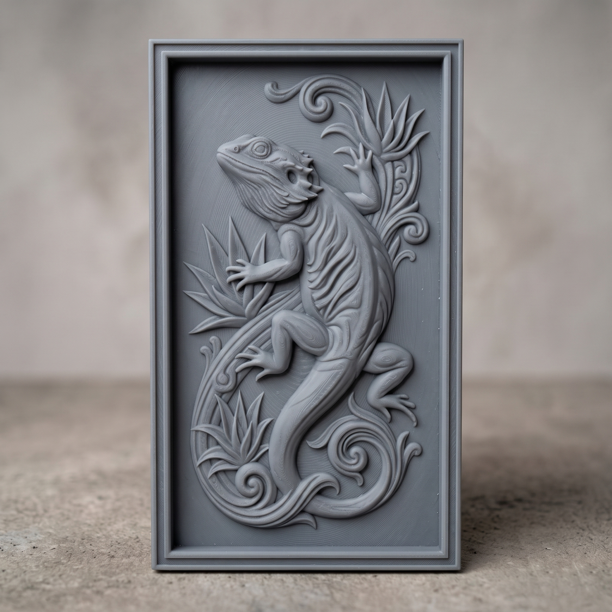 Detailed 3D bas-relief of a bearded dragon in a climbing pose, with spiky dorsal frill and beard scales, textured body scales, and one leg reaching onto a bird of paradise leaf. Tropical leaf motifs and a curling tail scrollwork fill the design, framed by a raised rectangular border. Carved texture with fine surface detail throughout. Designed for CNC relief carving, wood routing, resin casting, and 3D printing as wall decor.