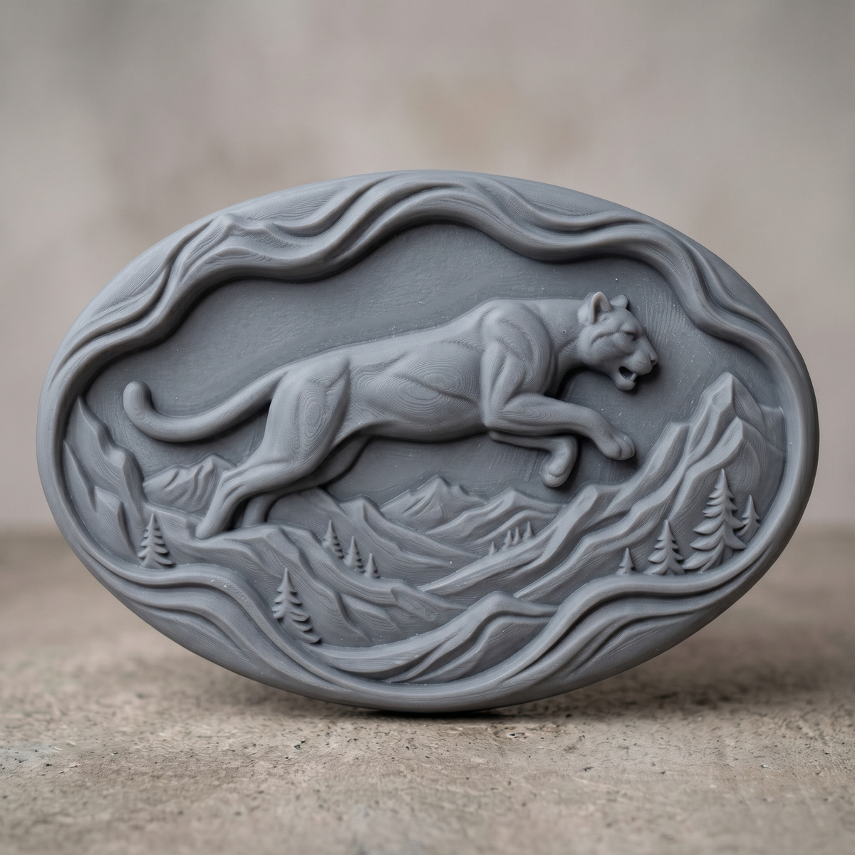 Leaping mountain lion carved in dark walnut wood on an oval wavy slab with flowing mountain ridges and pine trees, shown as a workshop mockup and a grey resin render. Digital STL relief file for CNC routers and 3D printers, ideal for wildlife wall art, panels and woodworking projects.